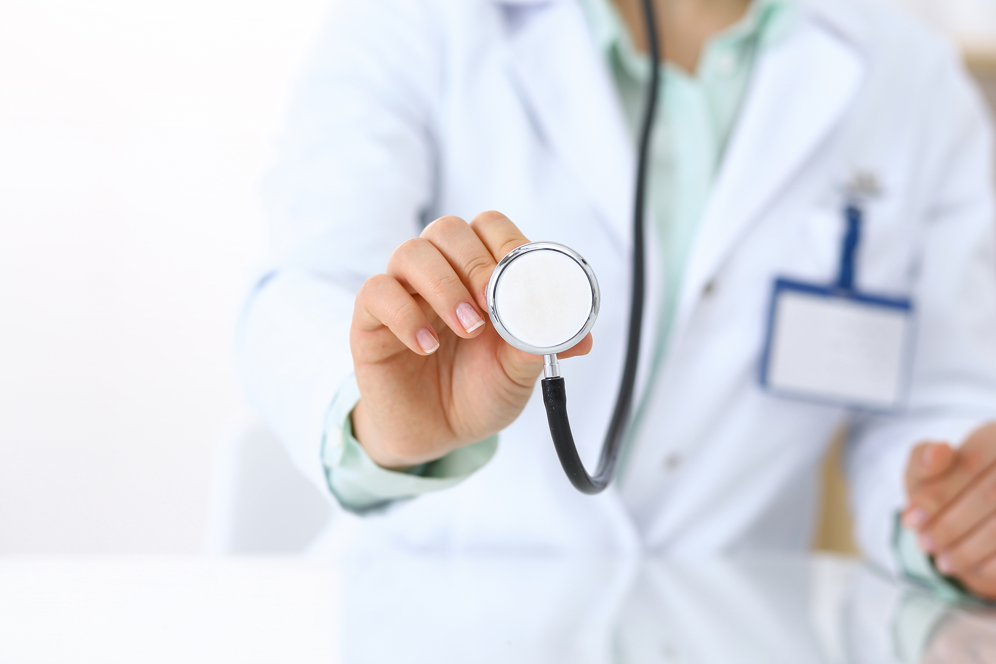 doctor holds stethoscope head, close-up. medical help and insura