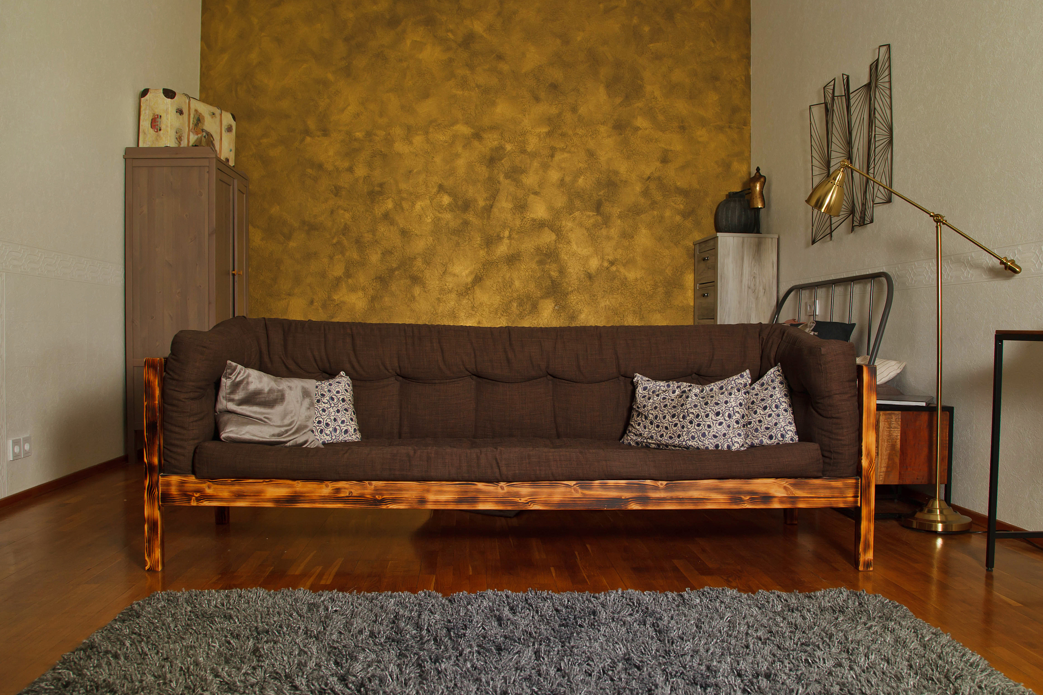 modern interior of living room with textured gold wall