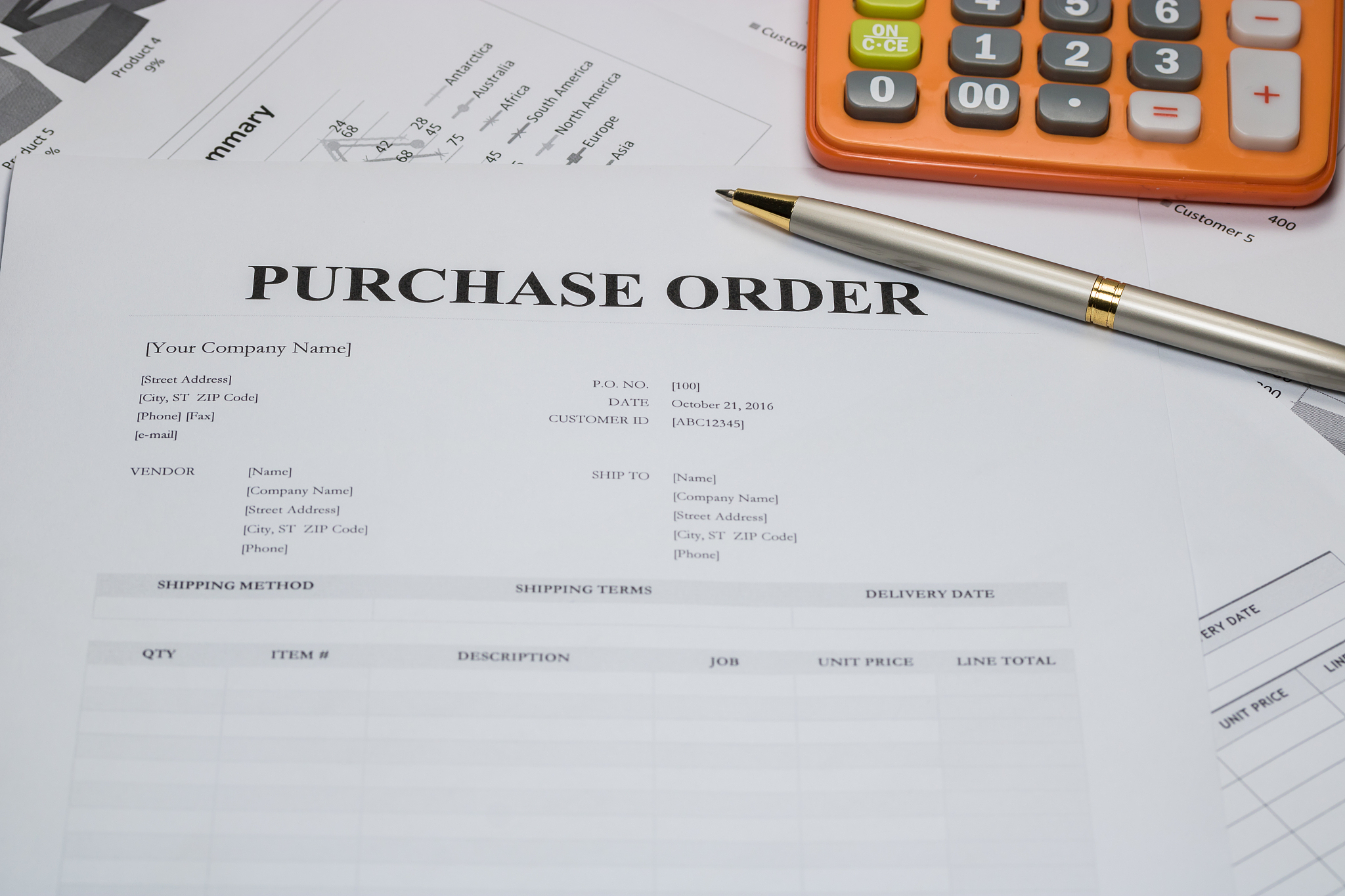 purchase order form with pen and calculator