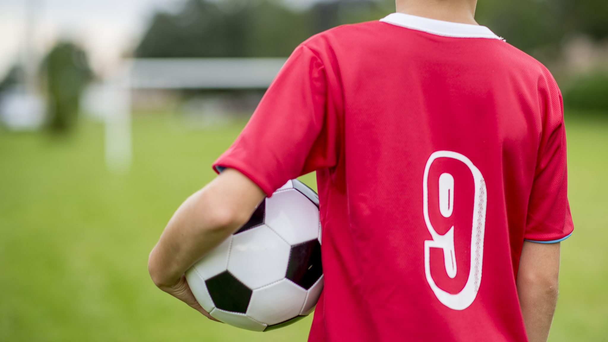 child holding a soccer ball