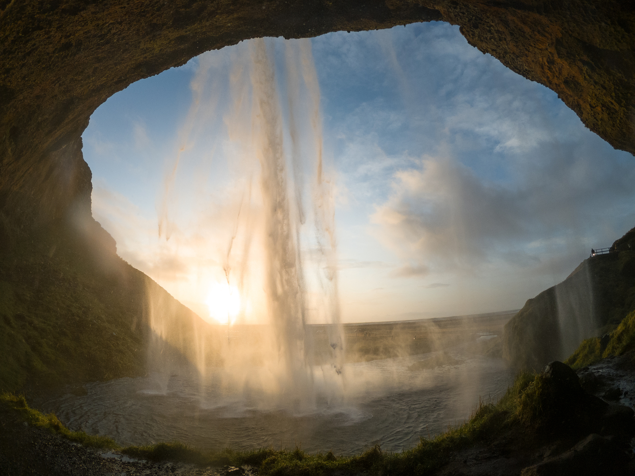 behind seljalandsfoss waterfall in iceland