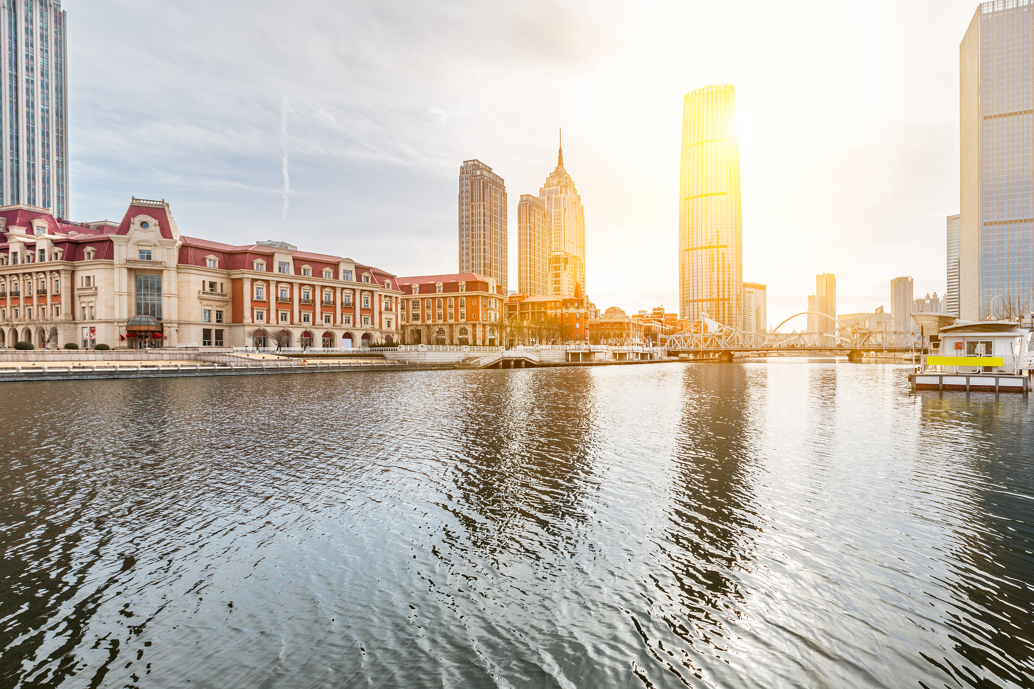 river and modern buildings against sky