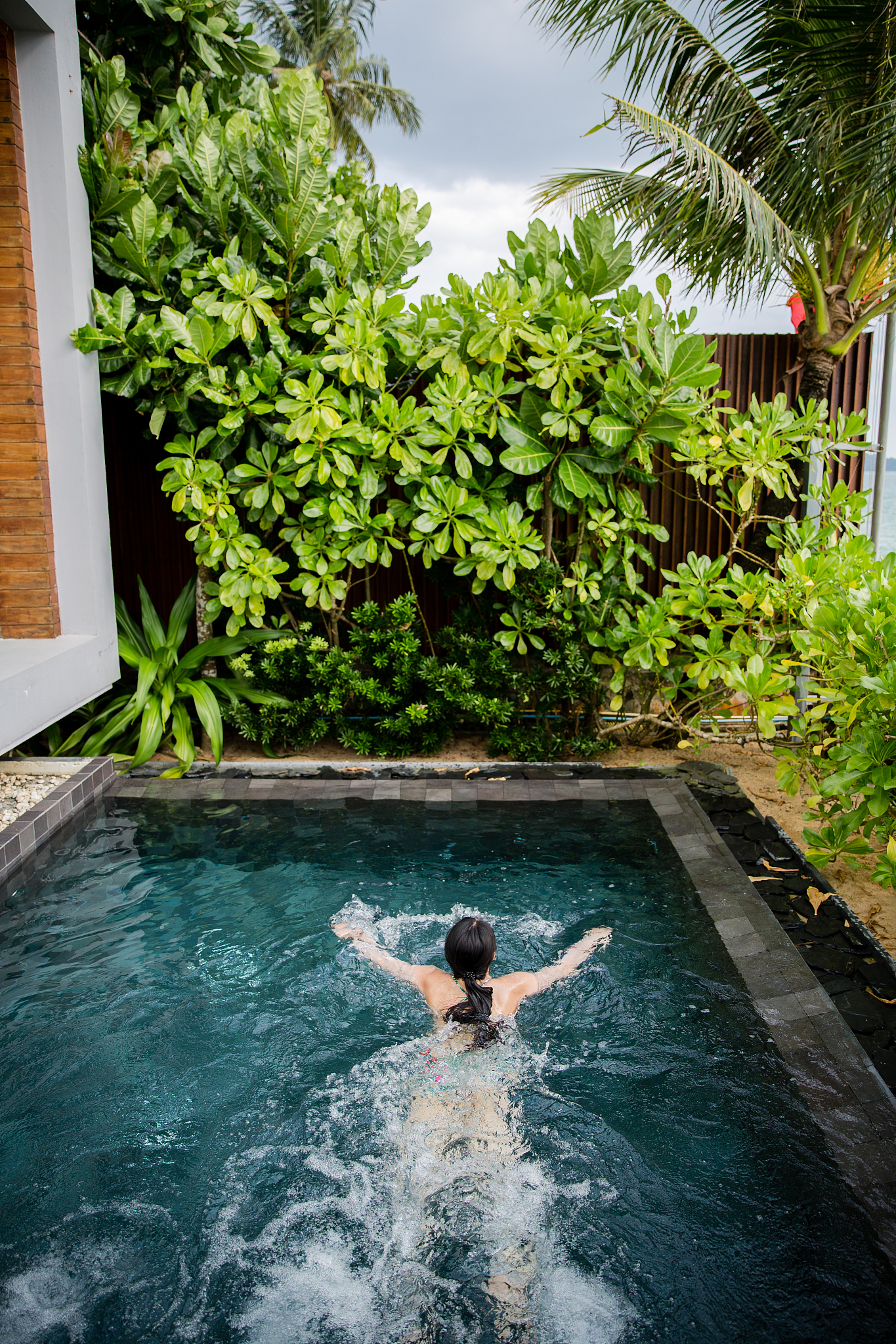 woman enjoying the swimming pool in takua pa, thailand