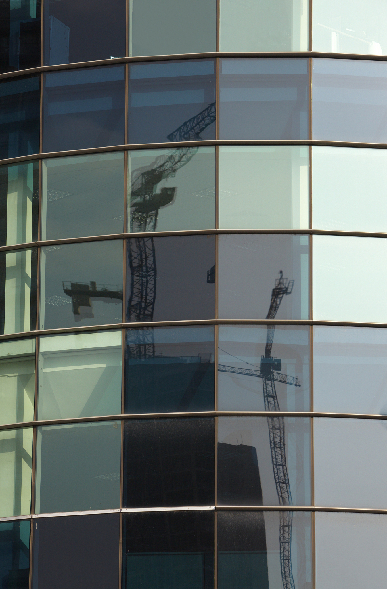 green glass office with crane reflection