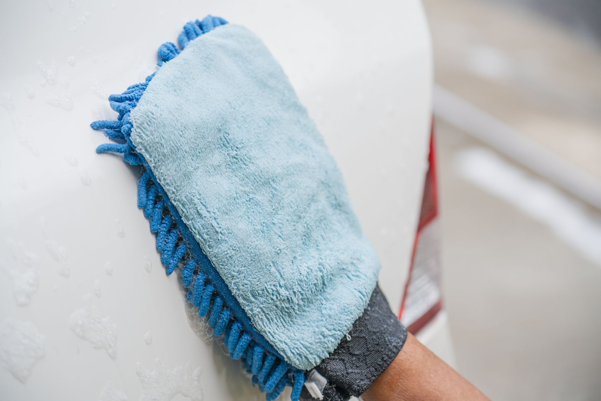 a man cleaning car with microfiber cloth, car detailing (or vale