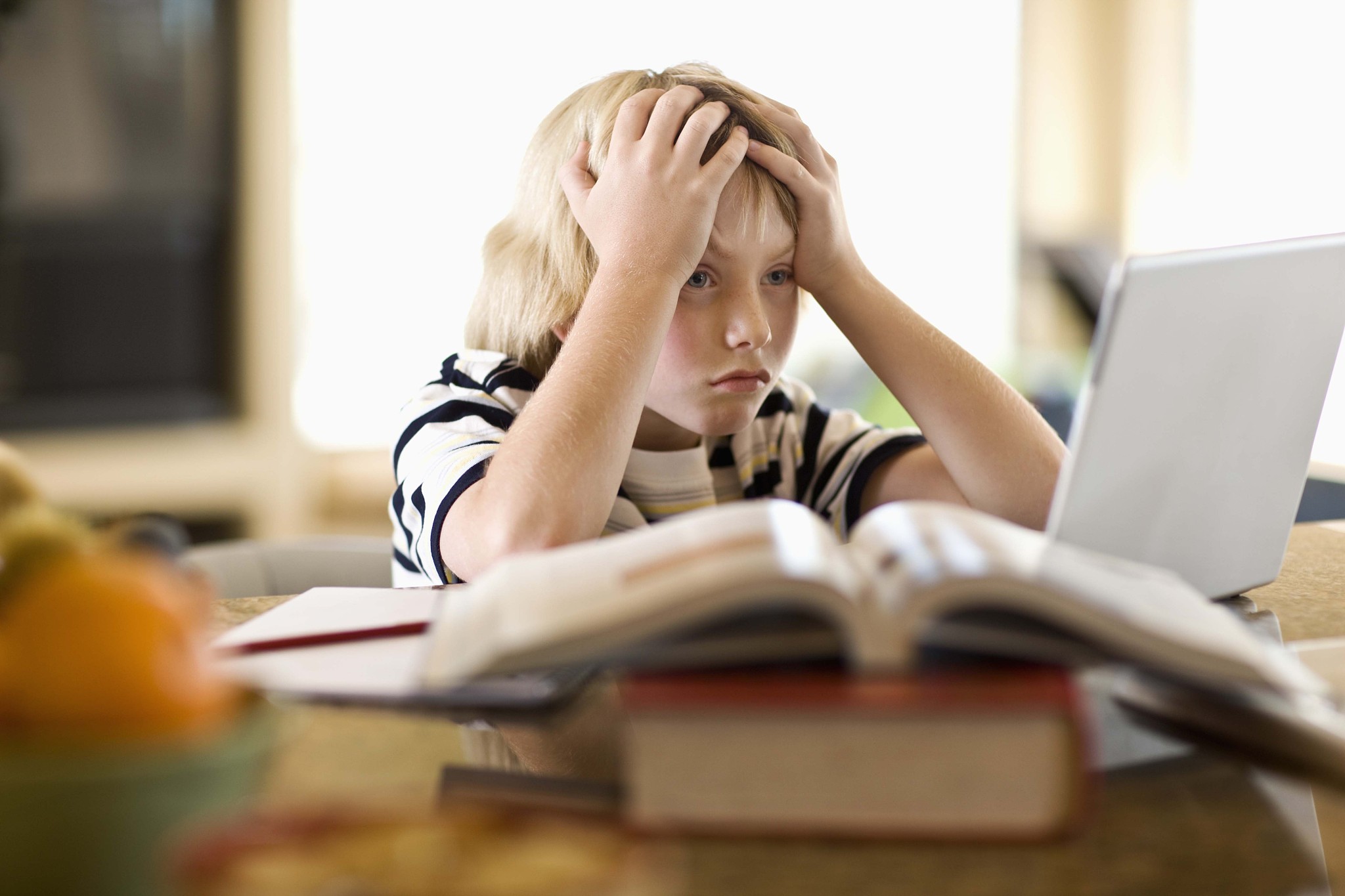 frustrated boy using laptop