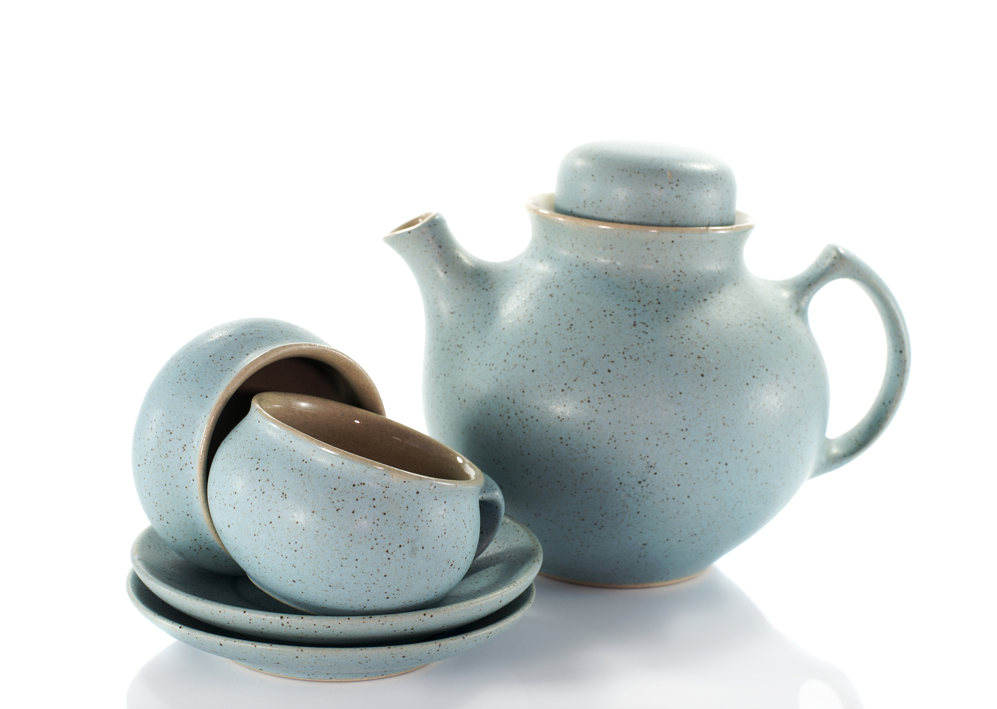 two crockery teacups and teapot