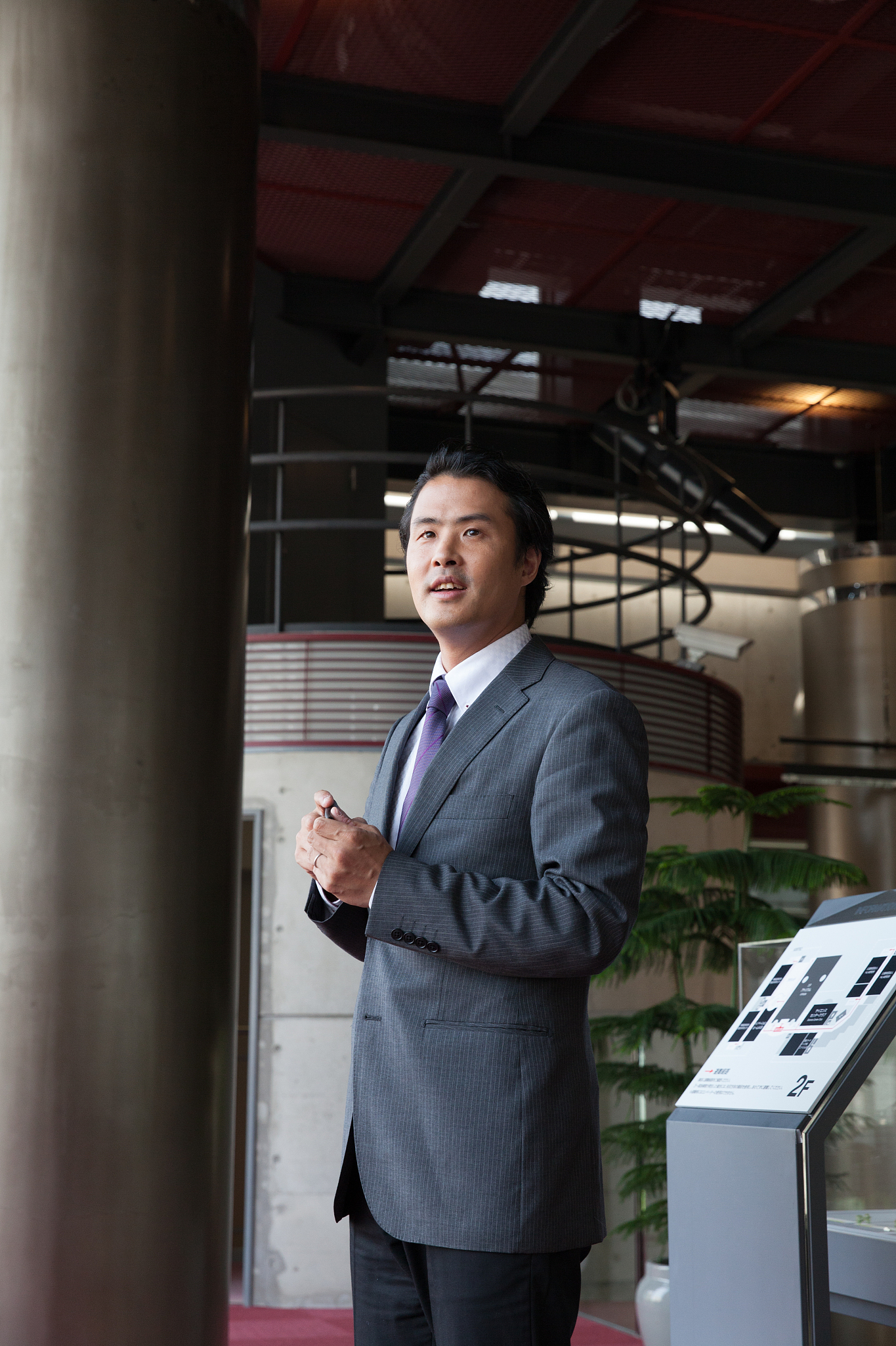 the businessman standing  in the lobby at office