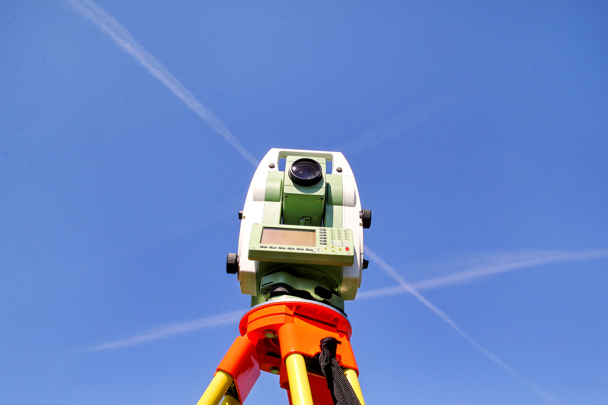 total station with blue sky in the background. survey instrument