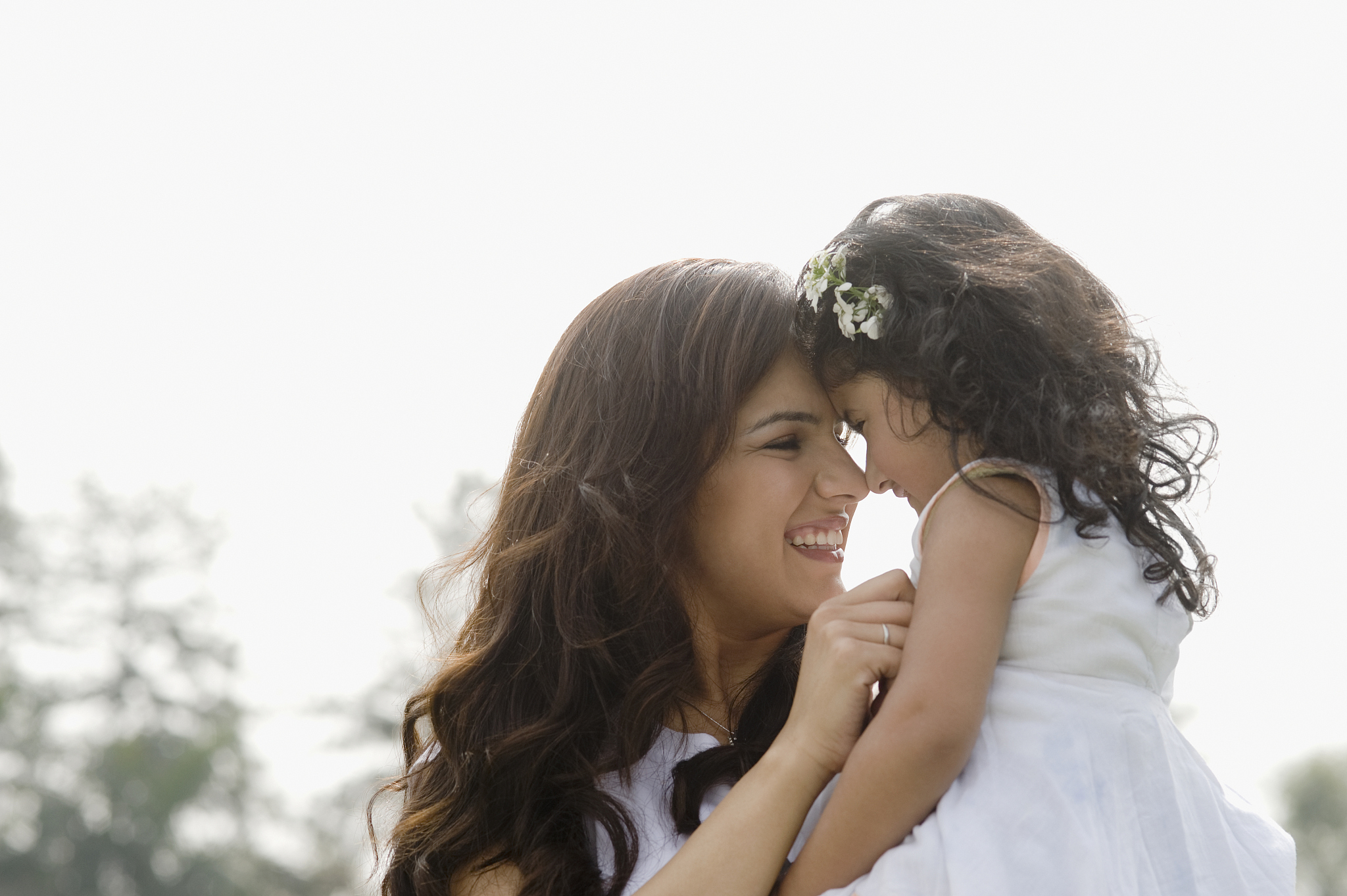 close-up of a woman nuzzling with her daughter