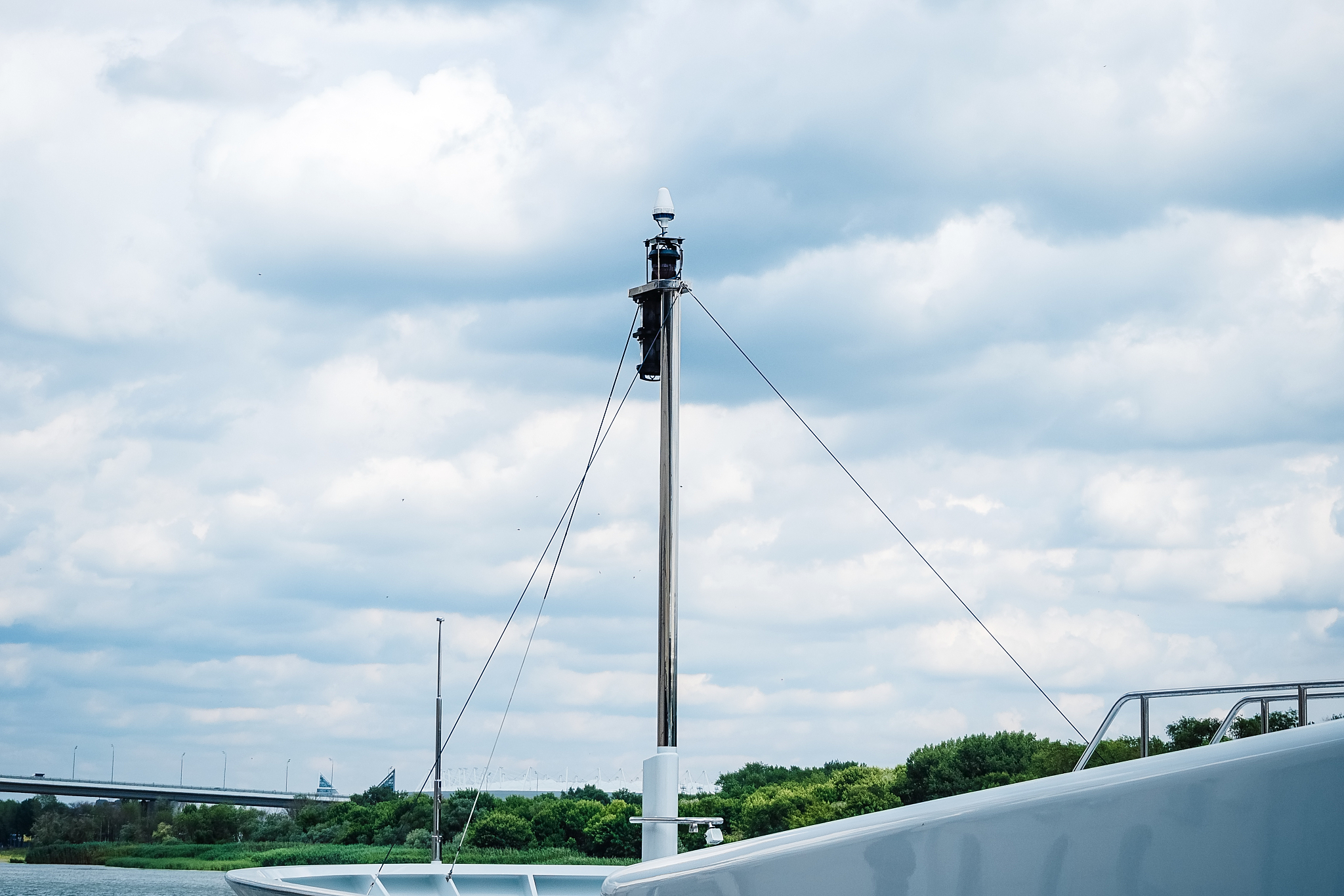 lantern on the nose of the yacht on the background of the river 