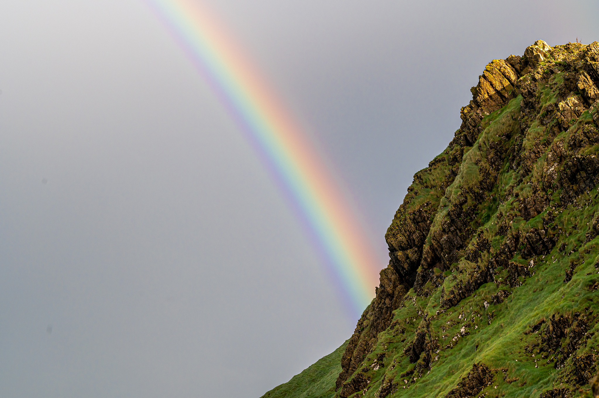 rainbow behind mountain ridge