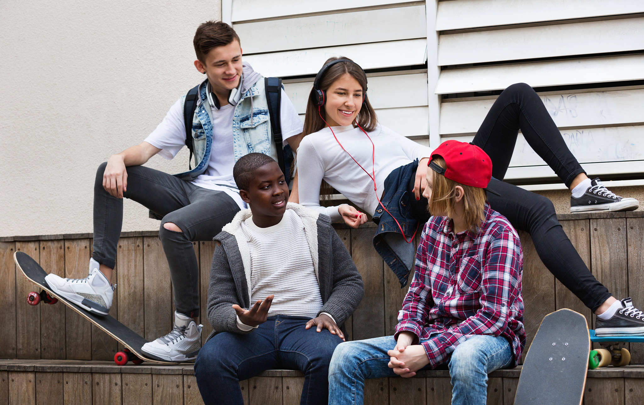 group of teenage friends relaxing and chatting