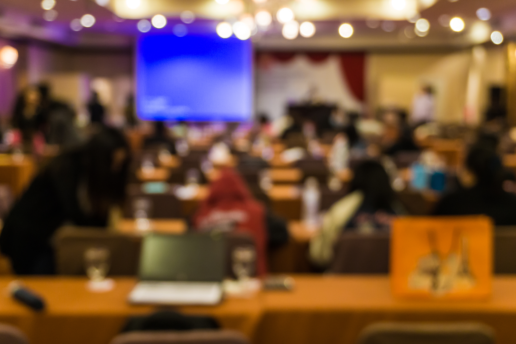 blurred people meeting in seminar room