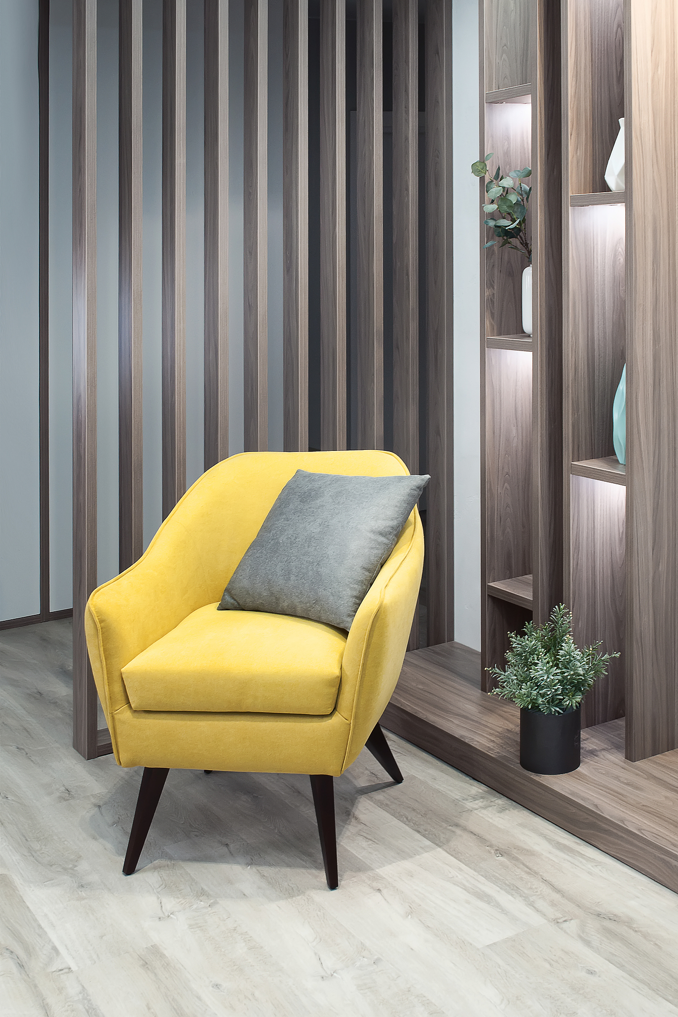 part of living room interior with yellow chair side view close u