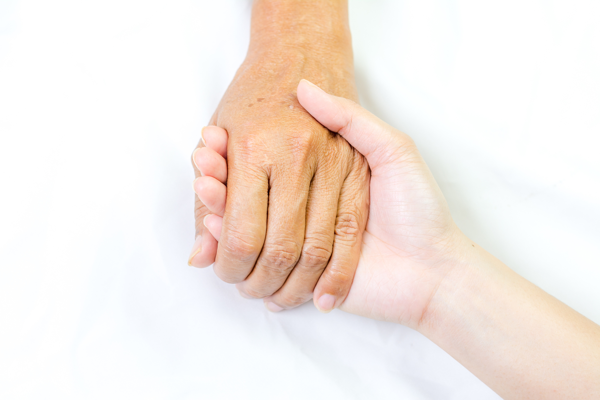 asian senior and asian young holding hands.