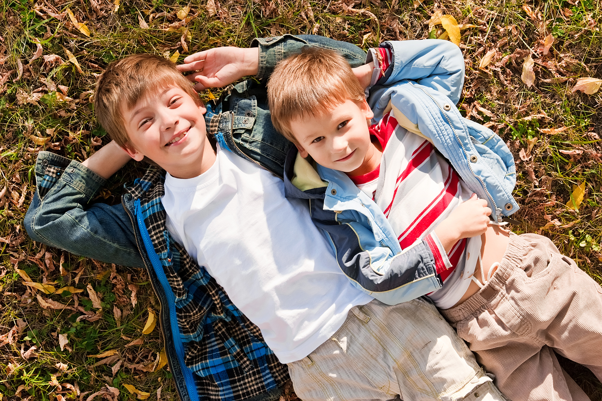 portraits of the boys lying on grass