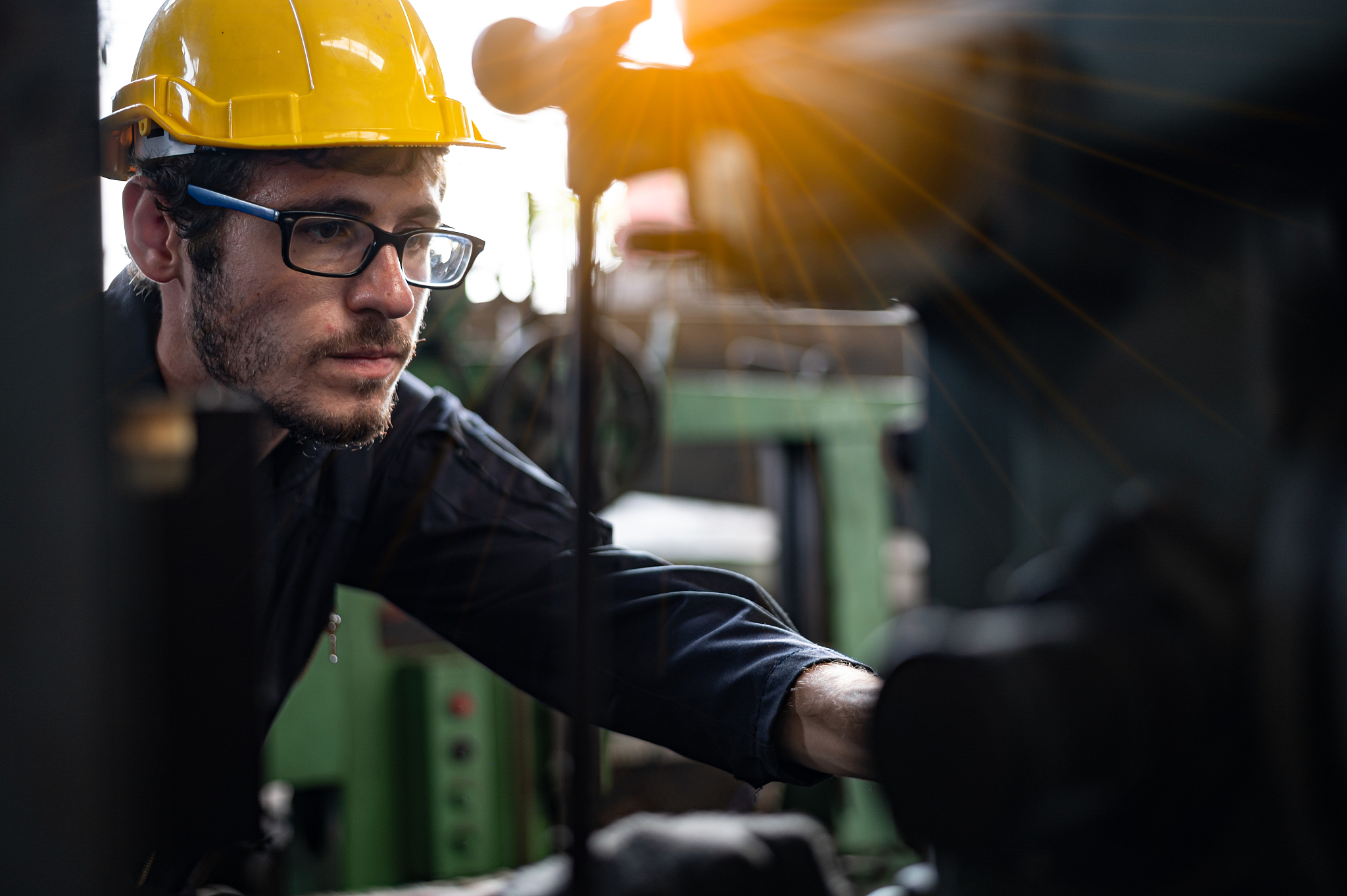 factory technicians work on the front of the machine.
