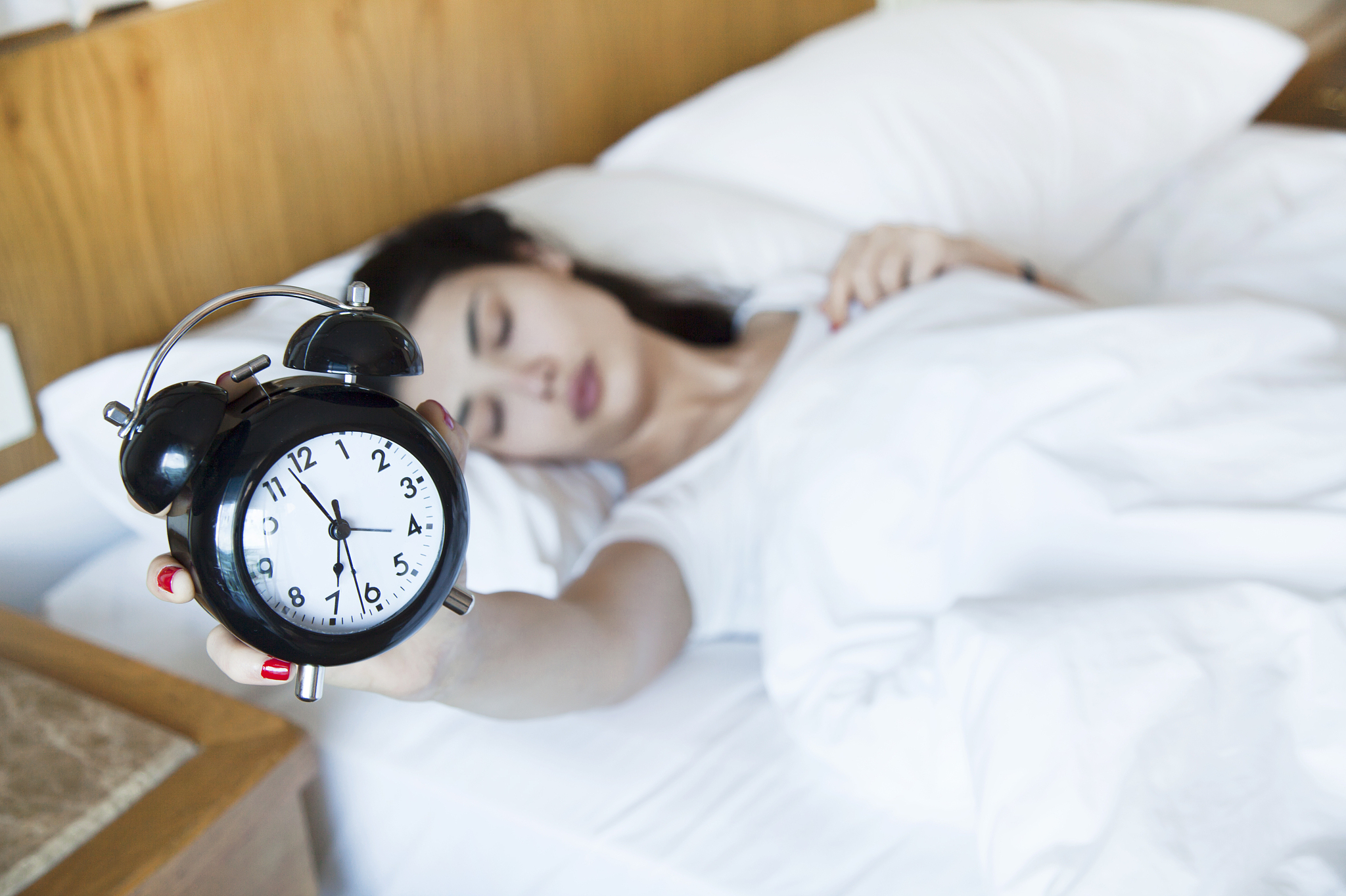 young woman finding it difficult to wake up in the morning
