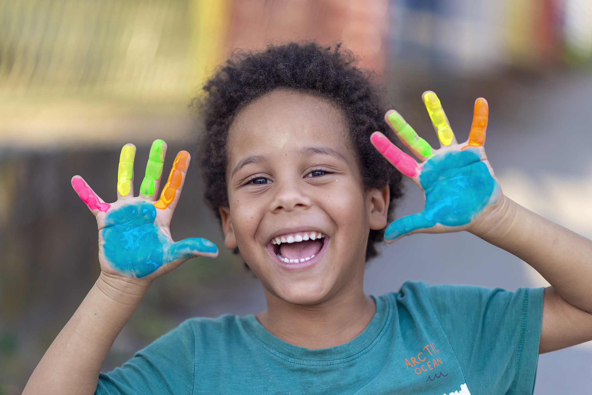 beautiful happy boy with painted hands