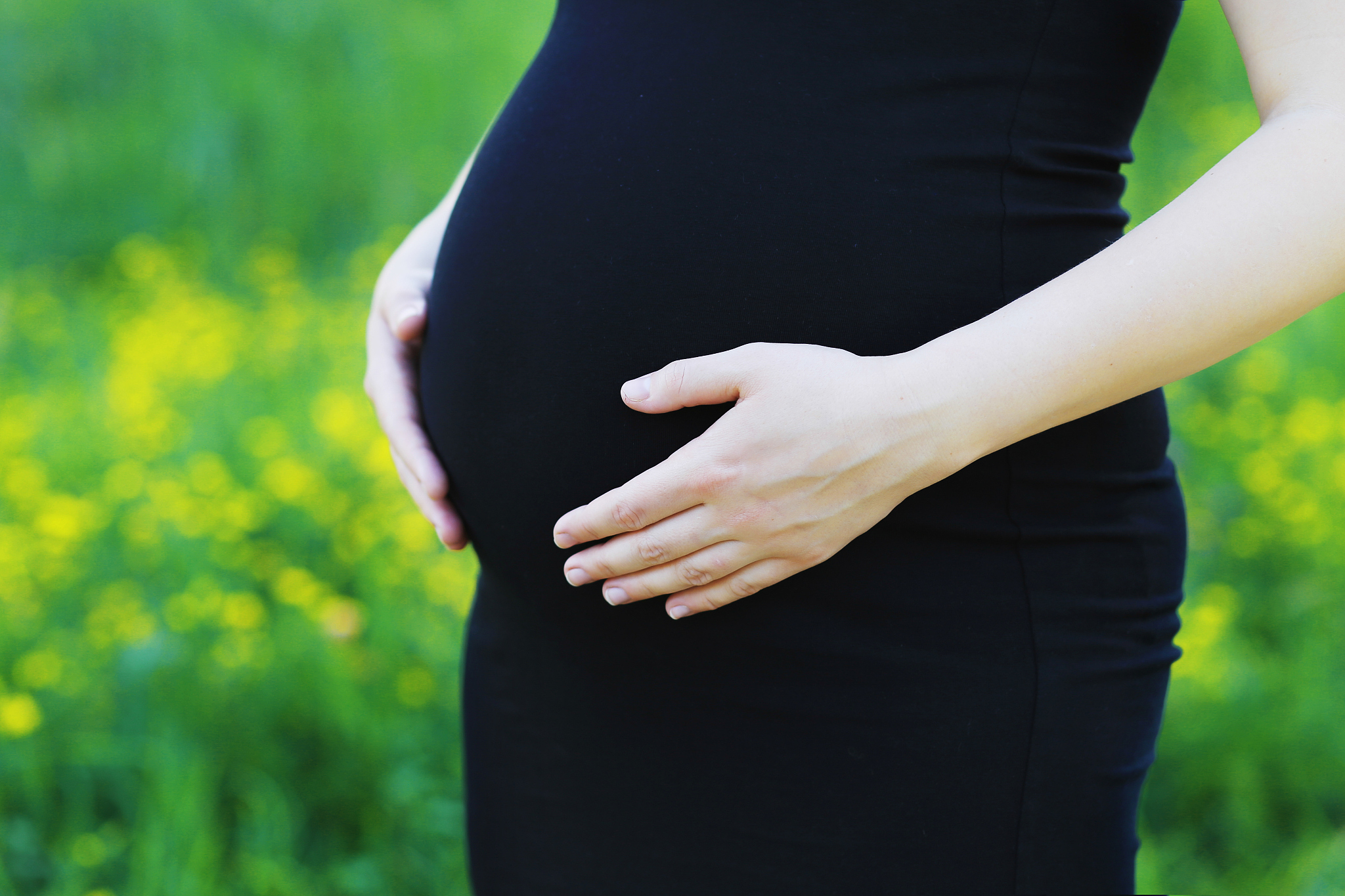 pregnant woman is in the black dress.