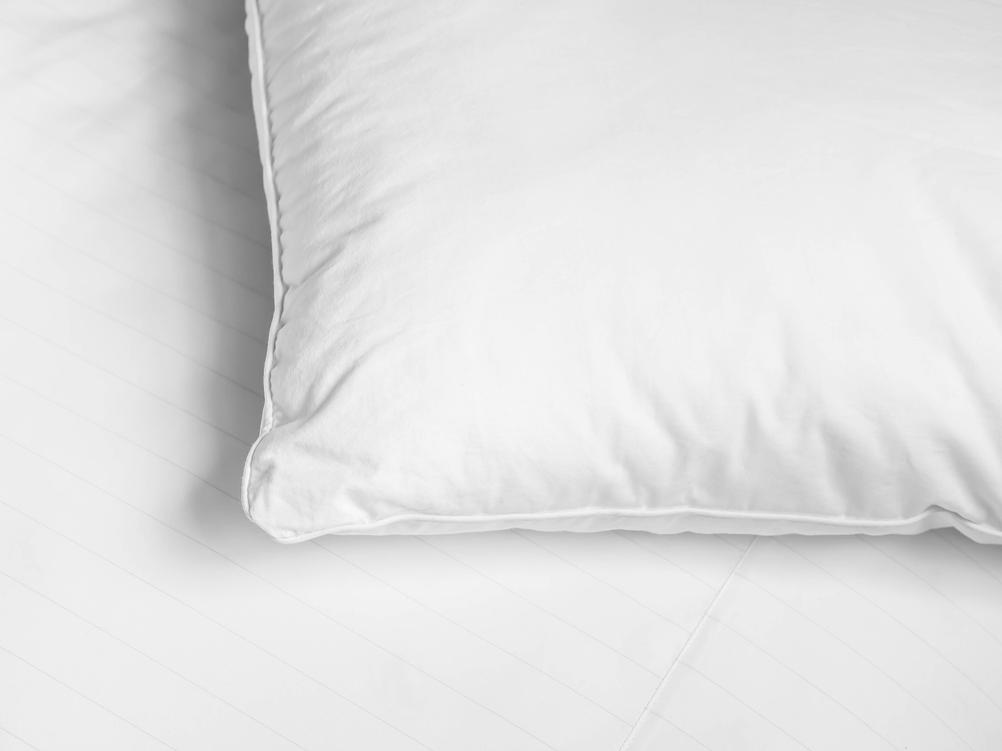 black and white tone. white pillow on the bed in the bedroom.