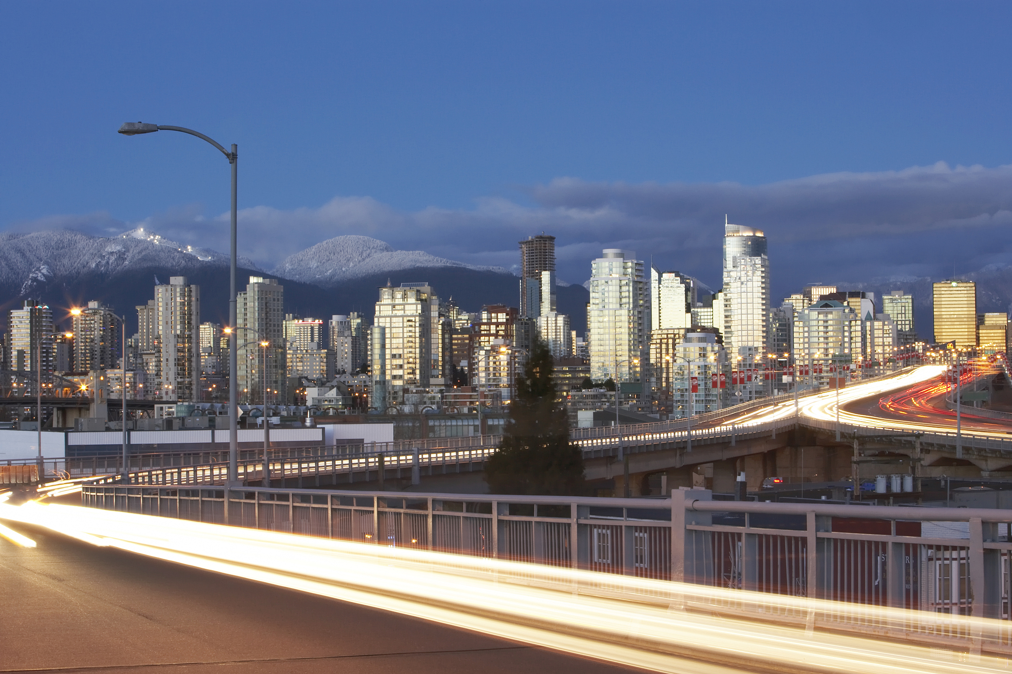 canada, british columbia, vancouver, city skyline at dusk, car l