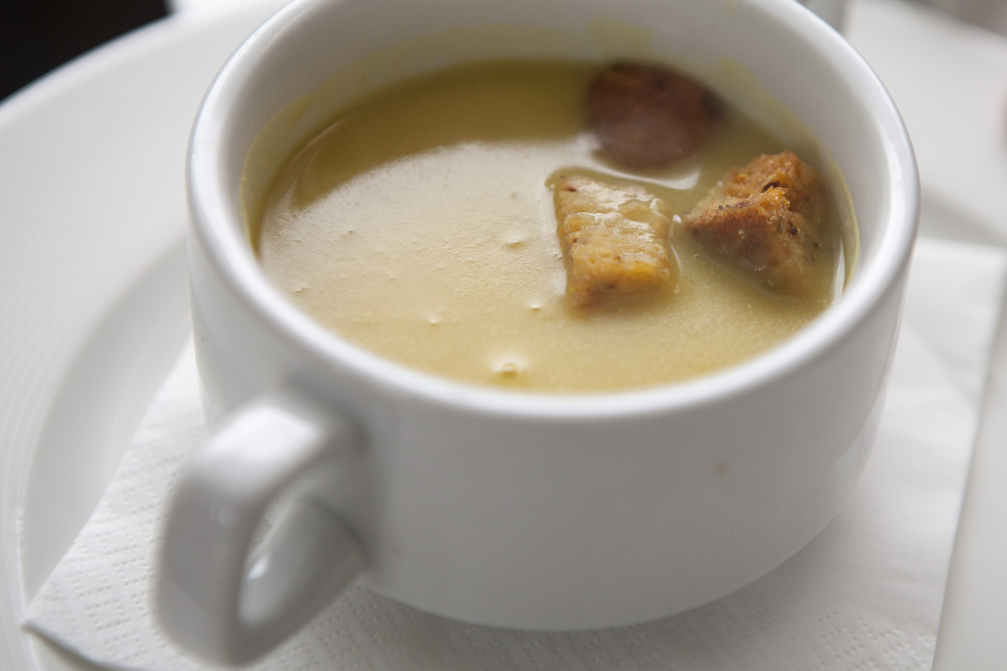 soup and croutons in white bowl