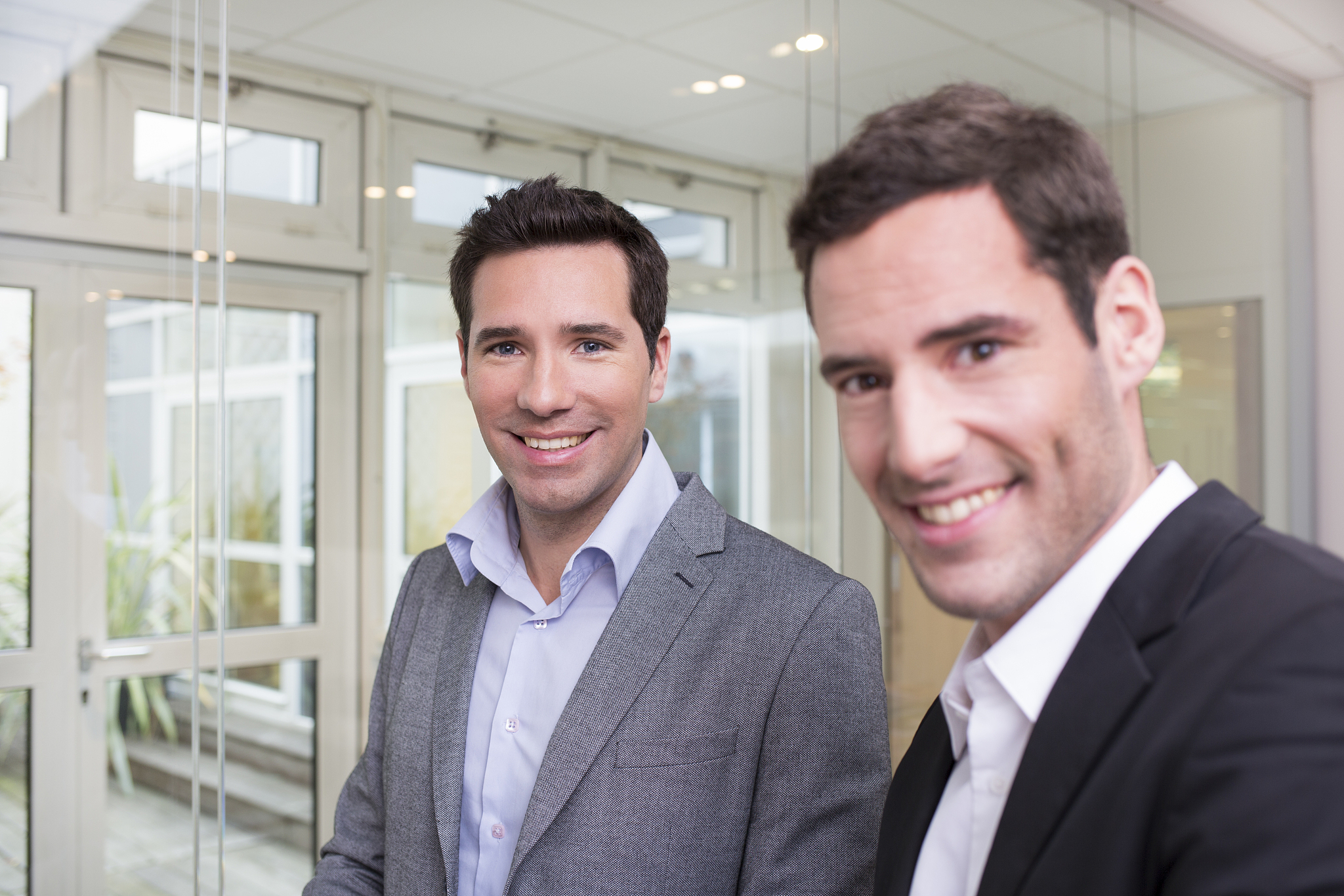 portrait of two casual businessmen working together in office
