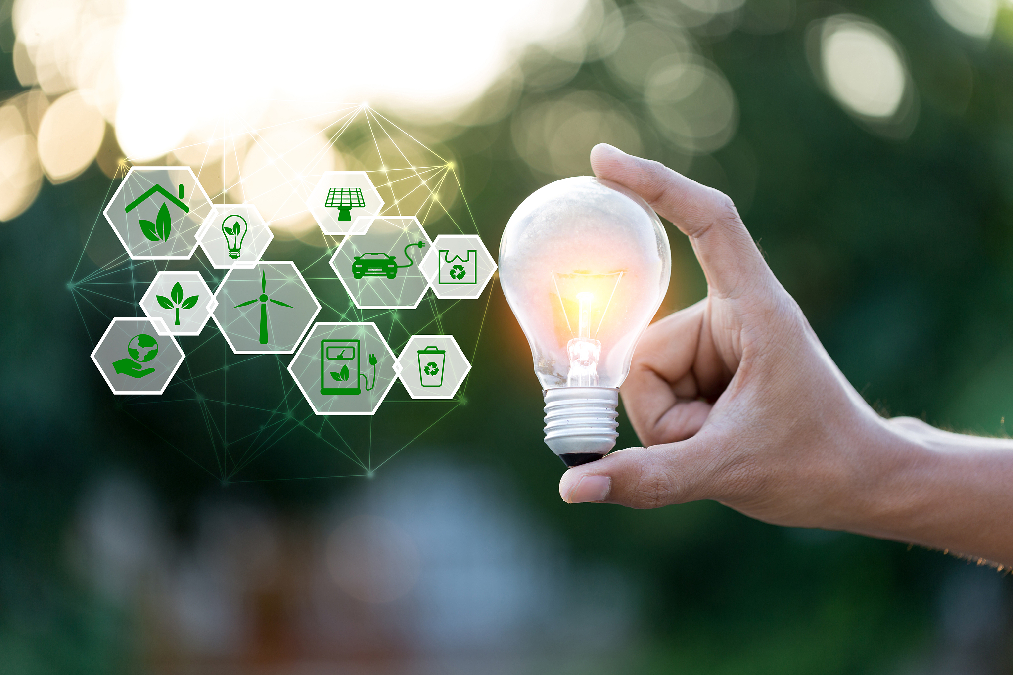 hand holding light bulb with icons energy sources for renewable,