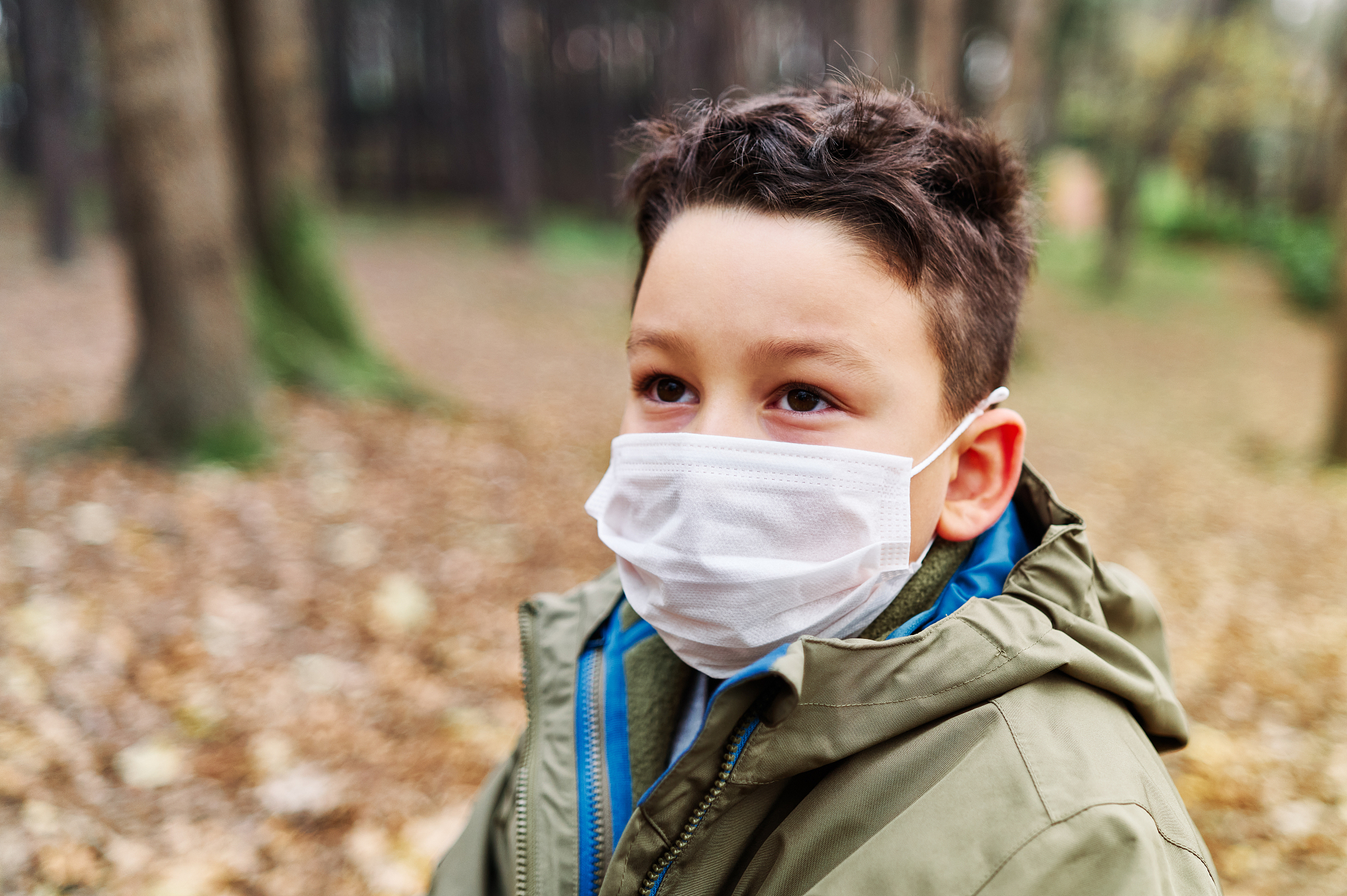 child on public park with surgical mask