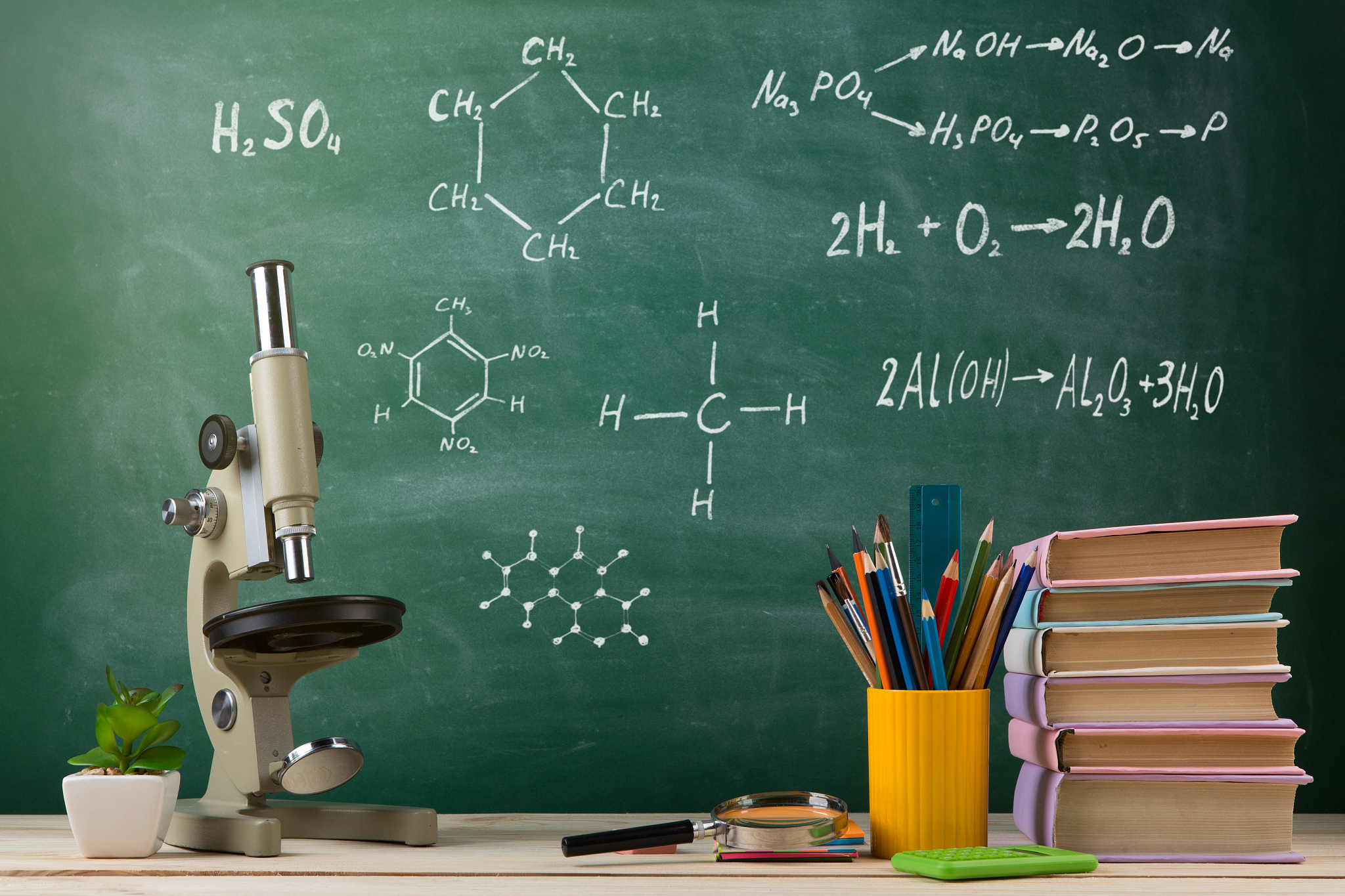 education and science concept - group of colorful books and micr