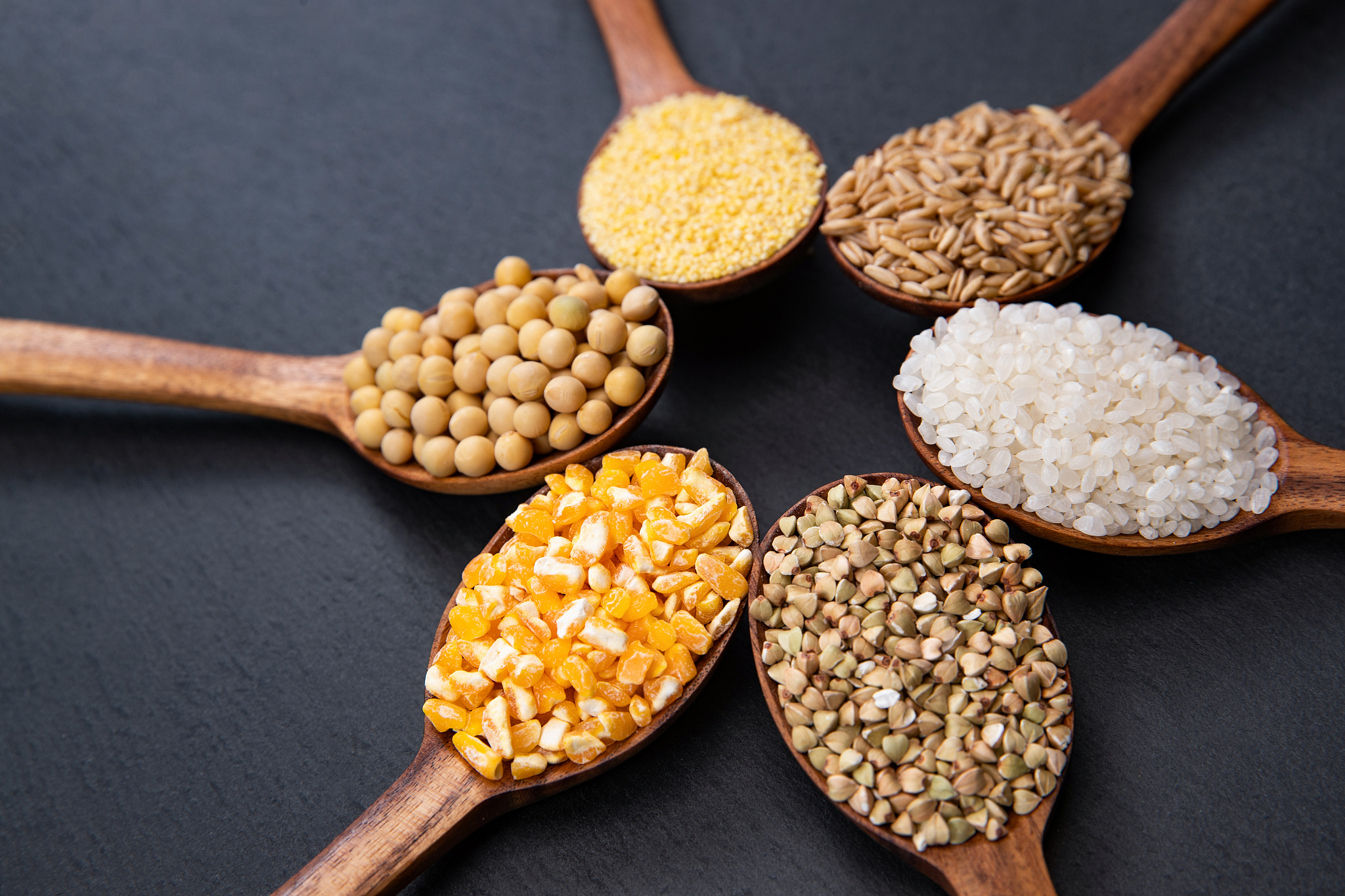 wooden spoon is filled with grain