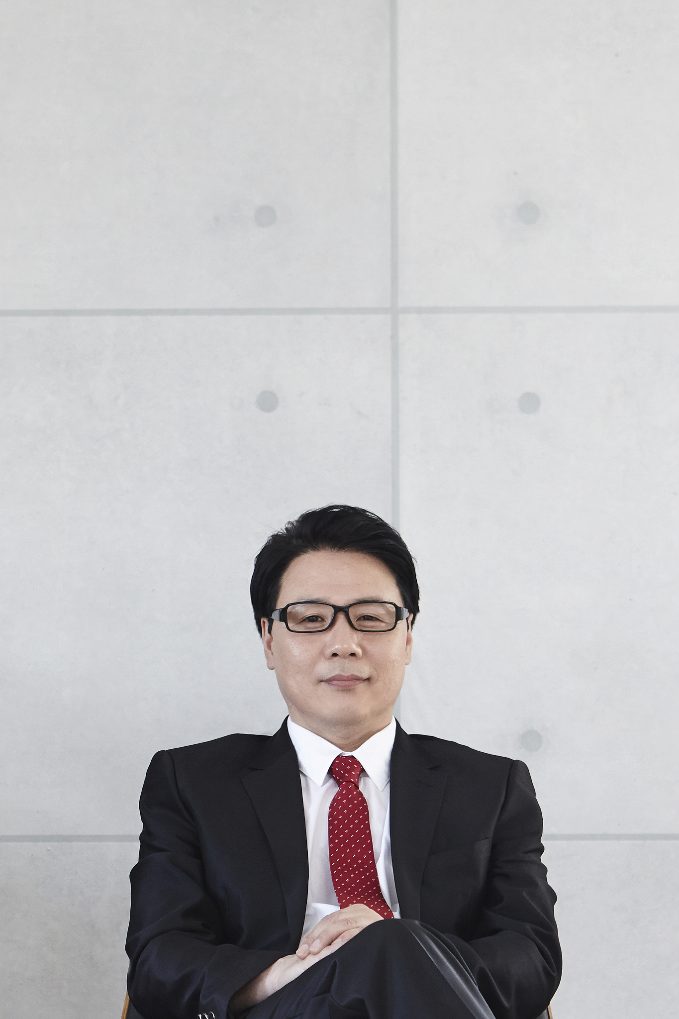 photography of businessman sitting legs crossed