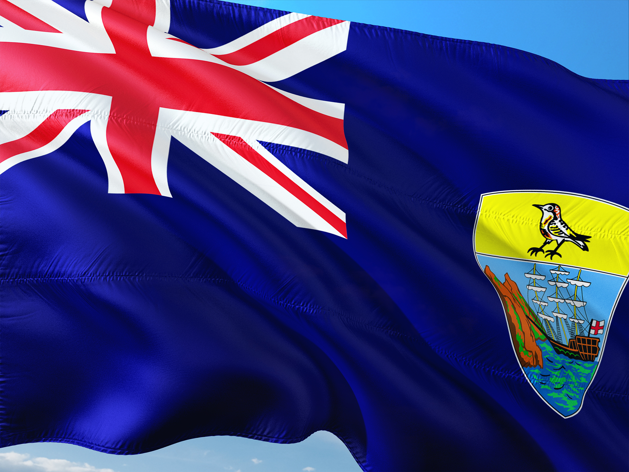 flag of saint helena waving in the wind against deep blue sky. h