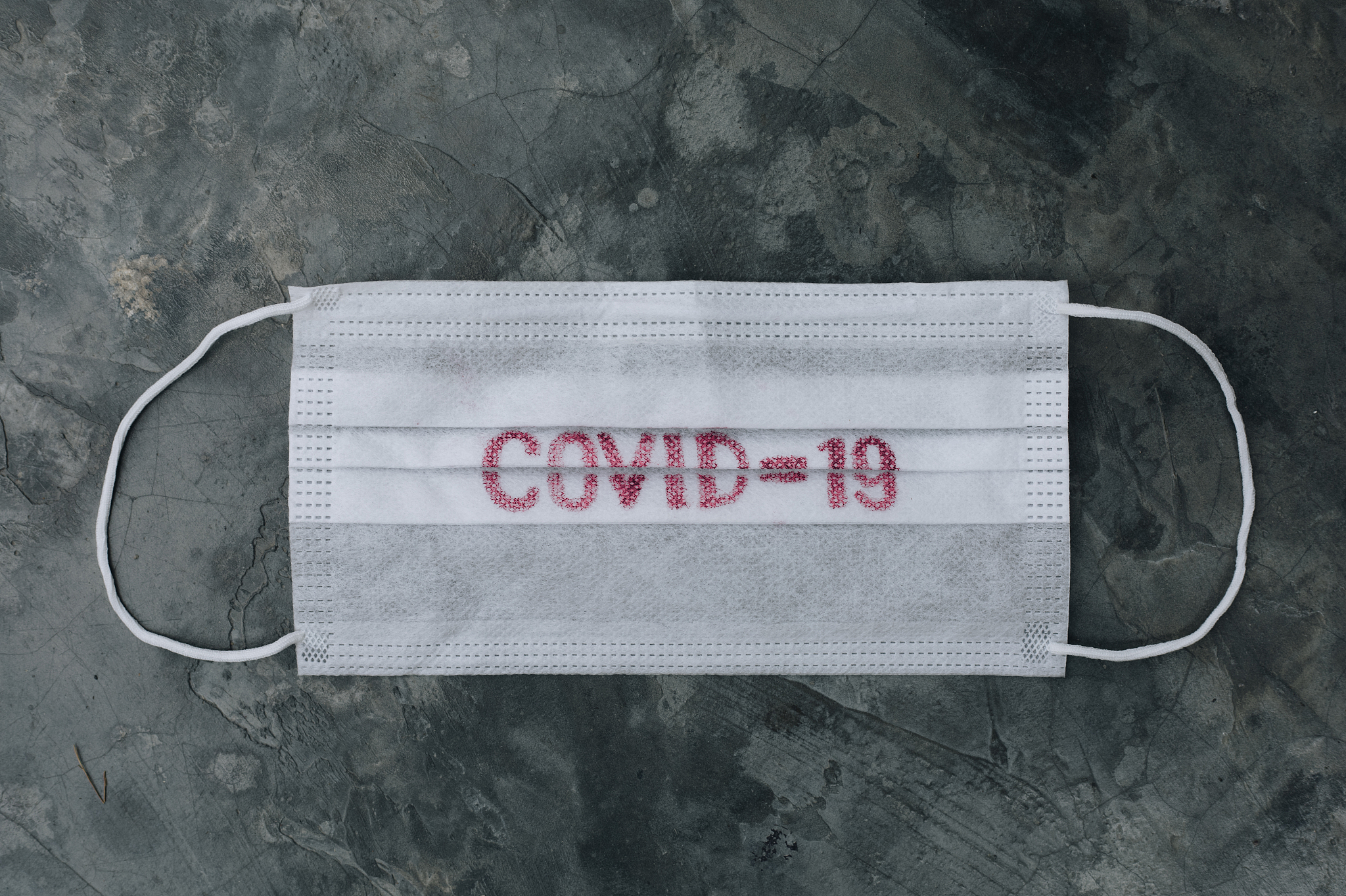 protection mask with text written on it covid 19 spread around t