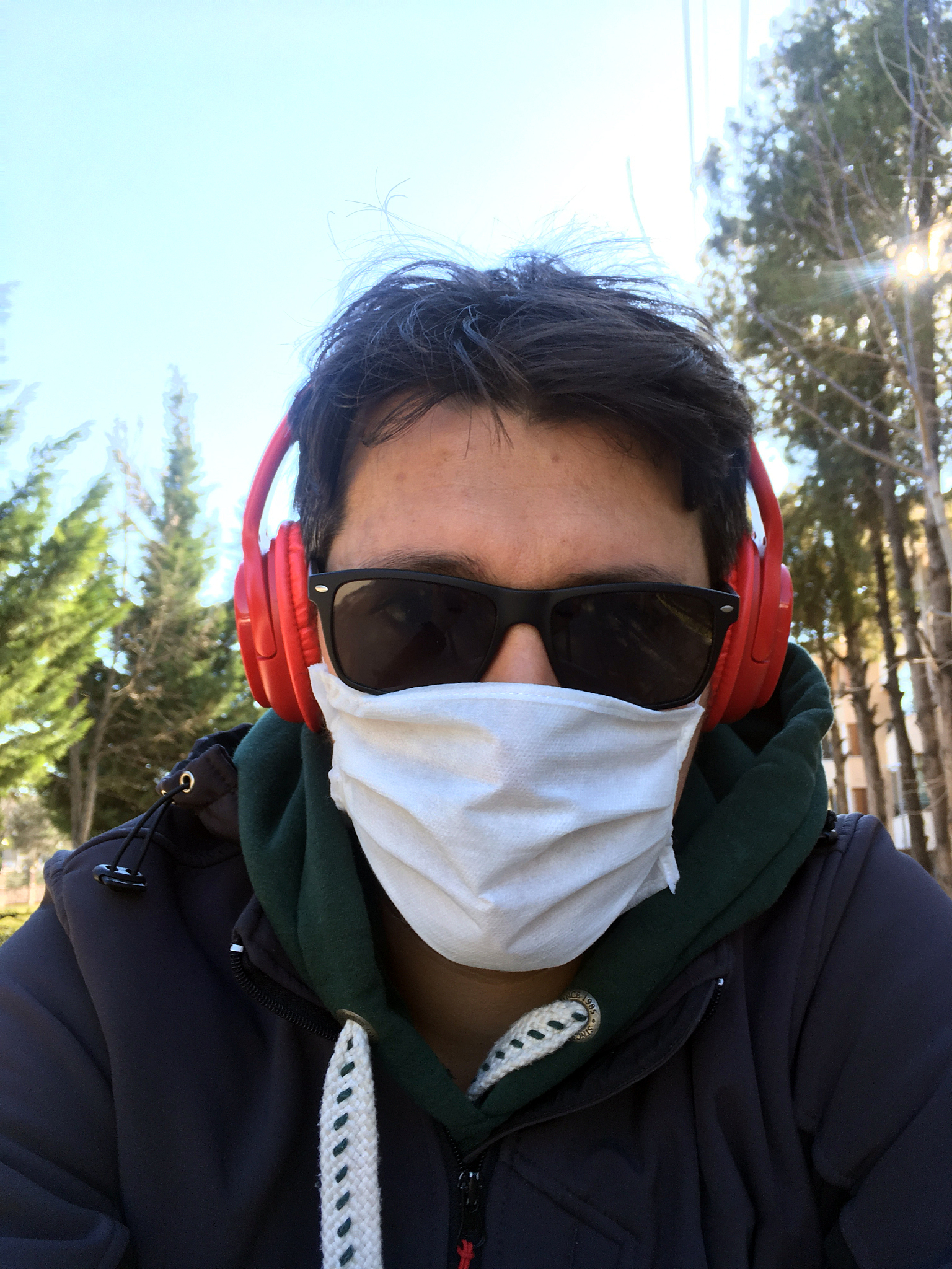 covid-19 pandemic coronavirus man in city street wearing sun gla