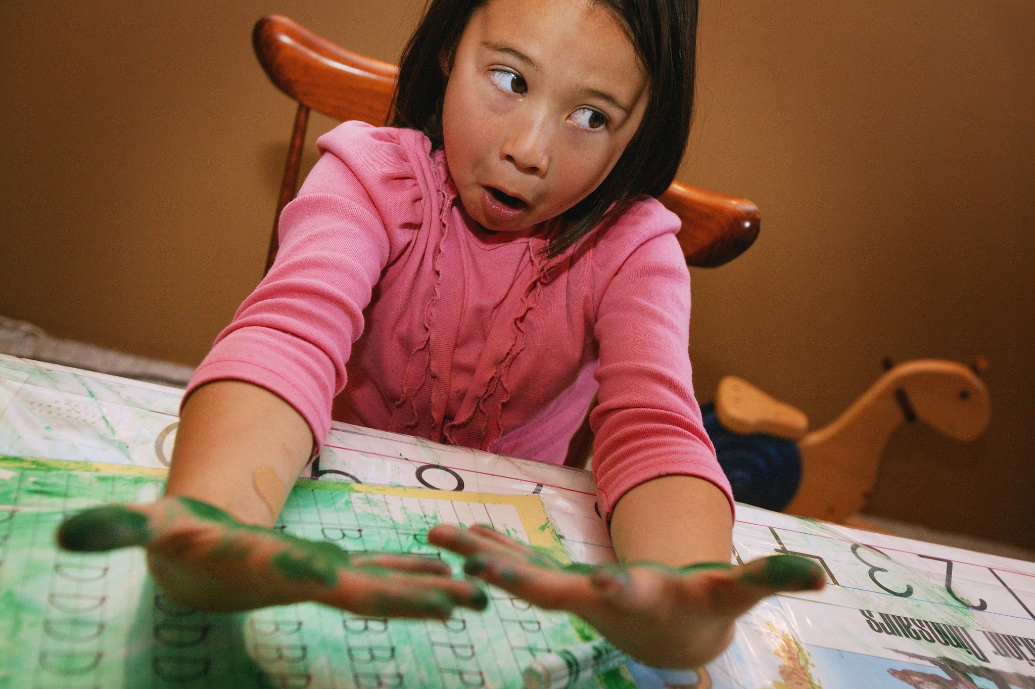 child with messy green hands