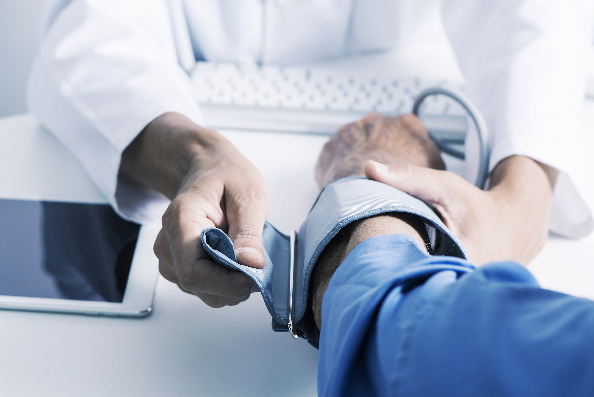 doctor measuring the blood pressure of a senior