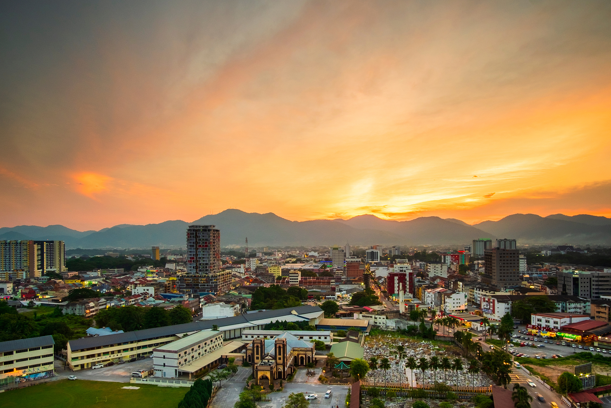 high angle view of cityscape against orange sky