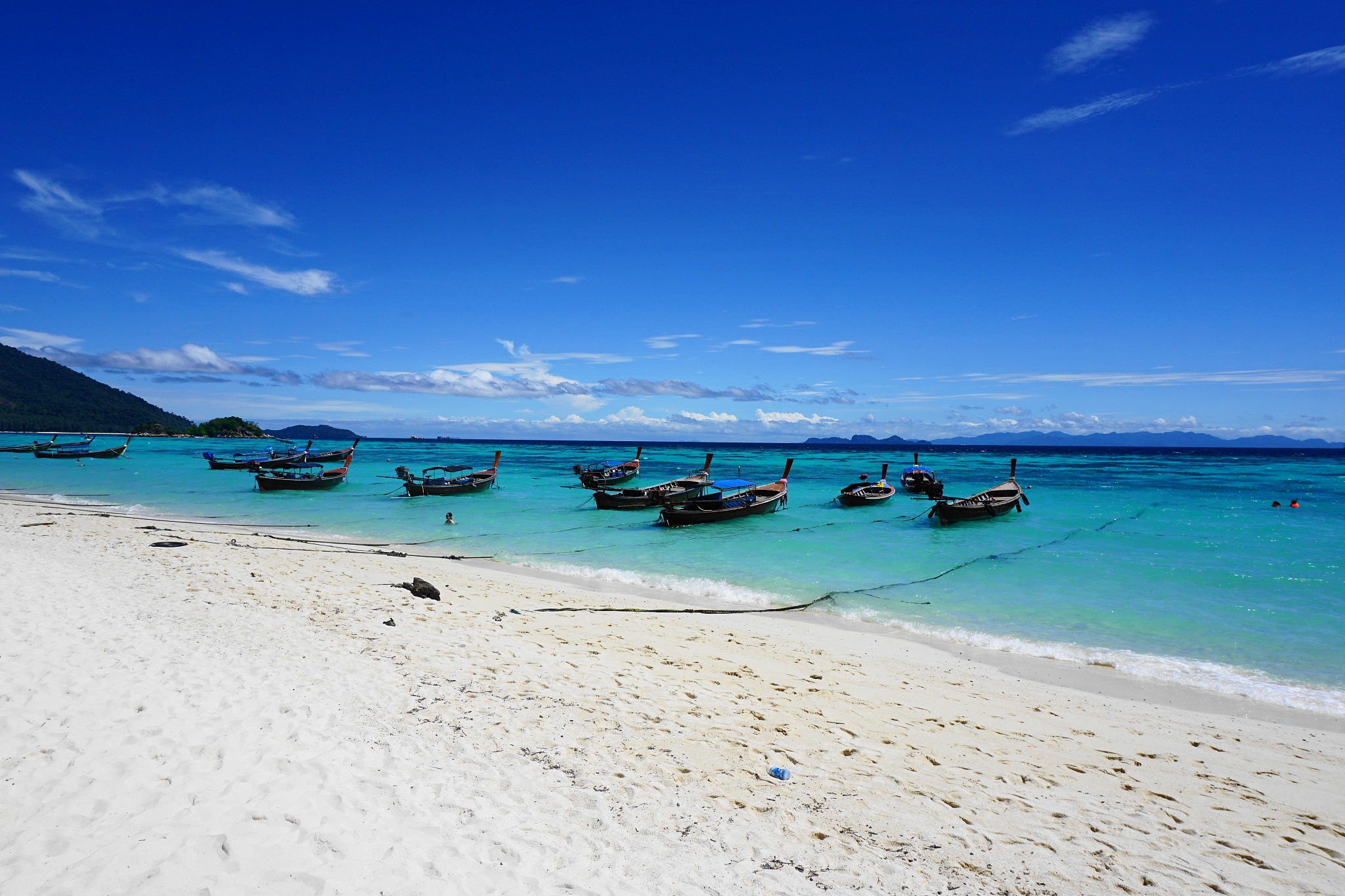 scenic view of beach against blue sky