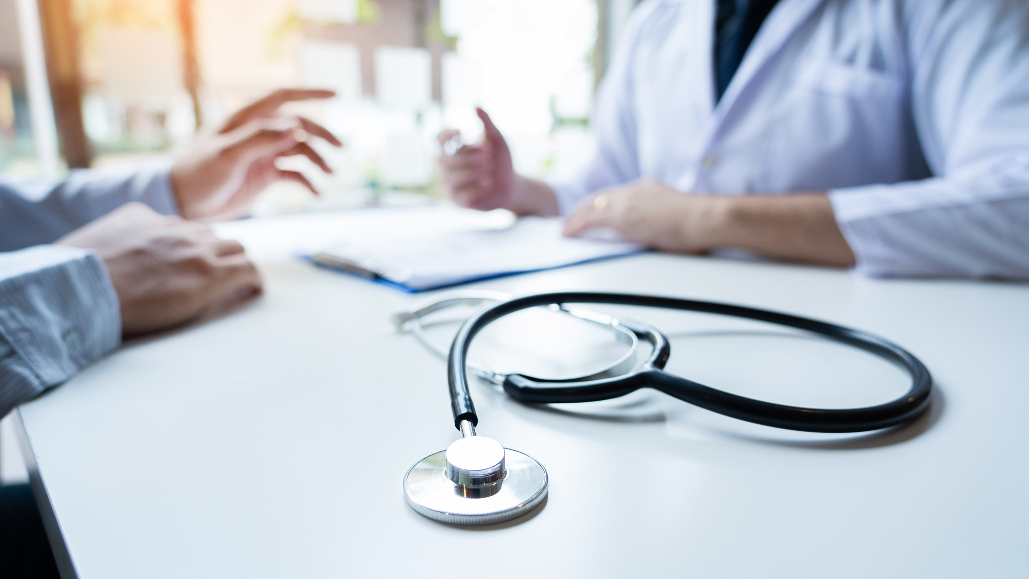 focus on stethoscope and background doctor checkup on patient a 