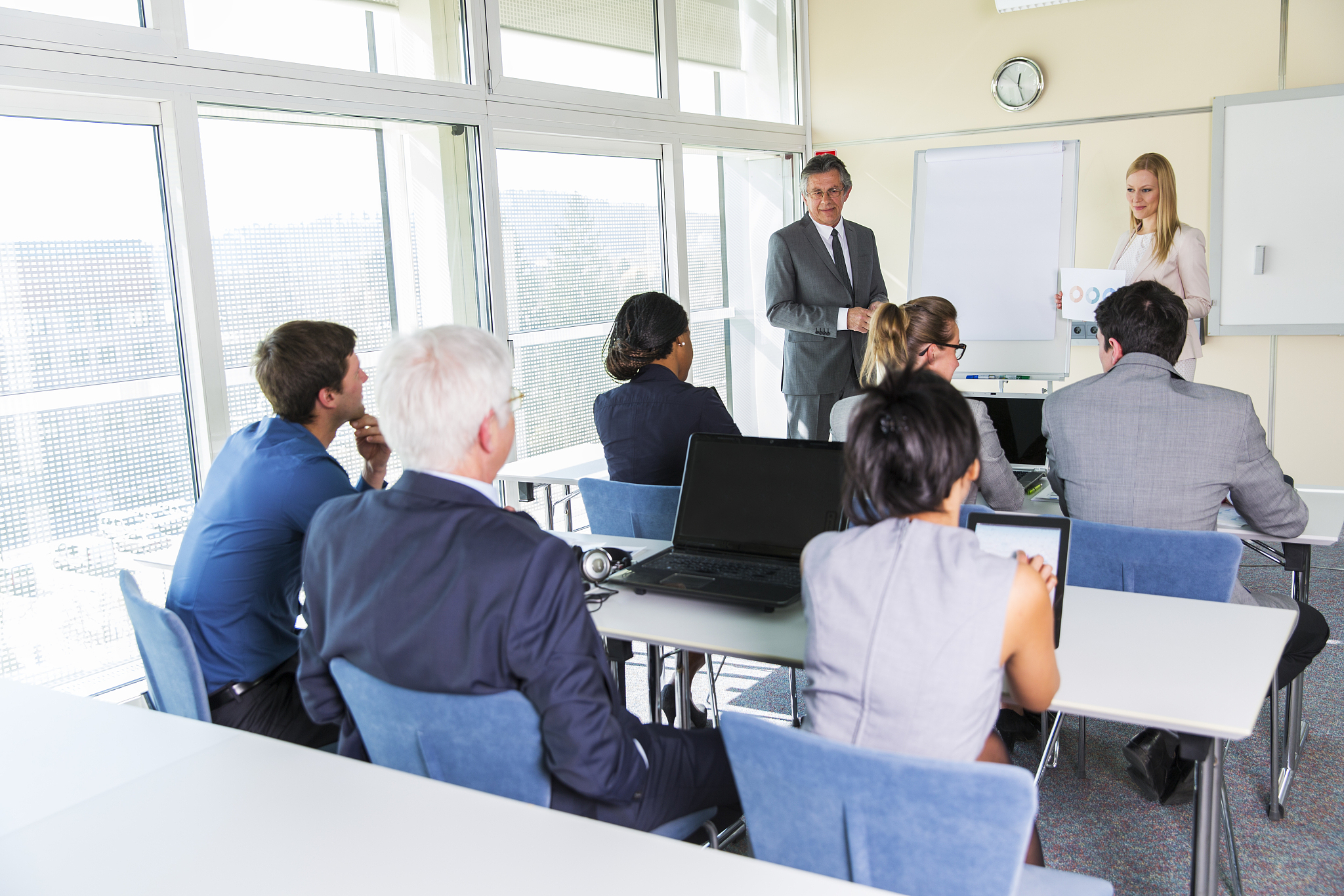 business people in education room listening lecture of senior te