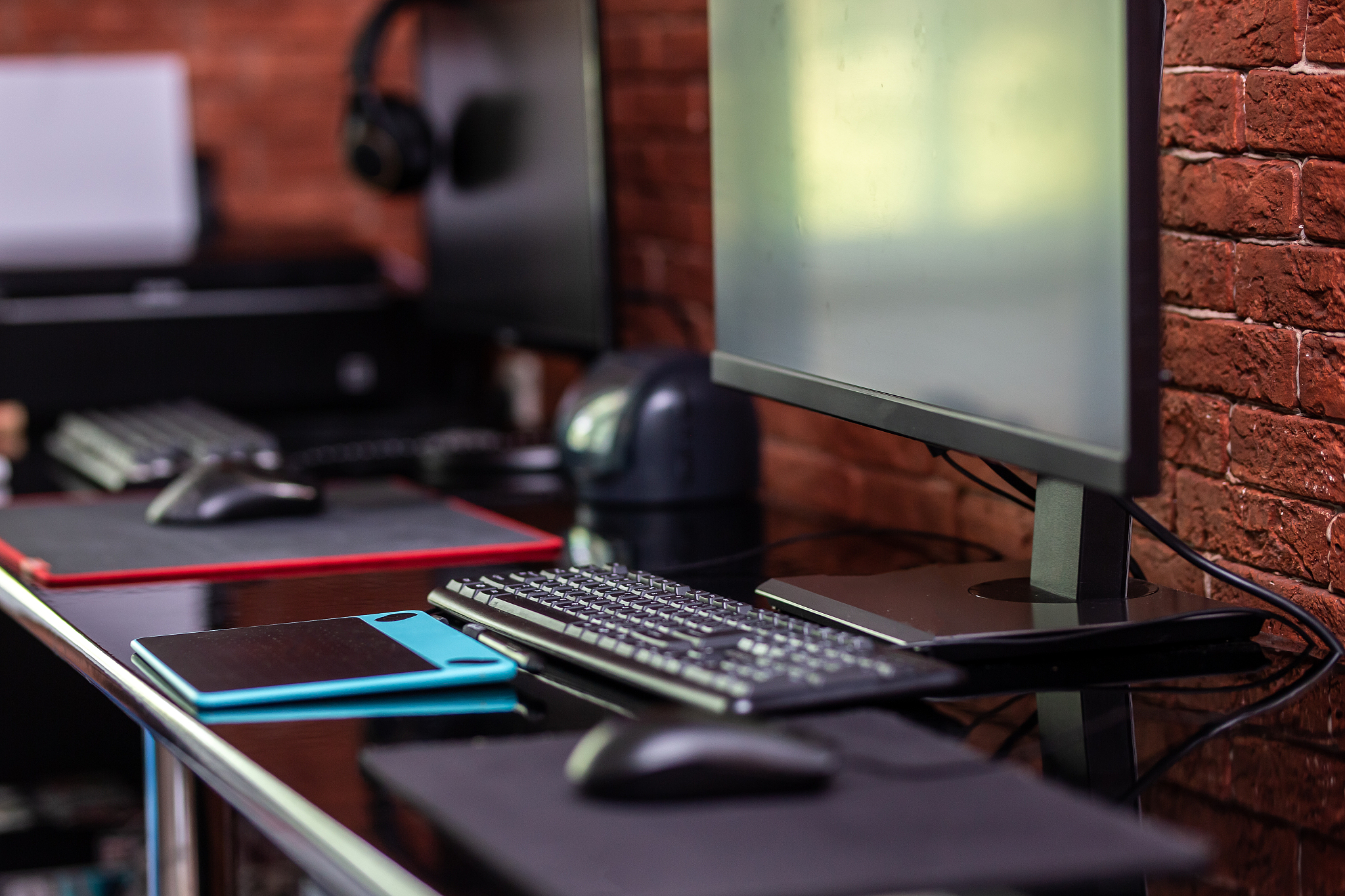 two computer monitors with black screen on a desk, one workplace