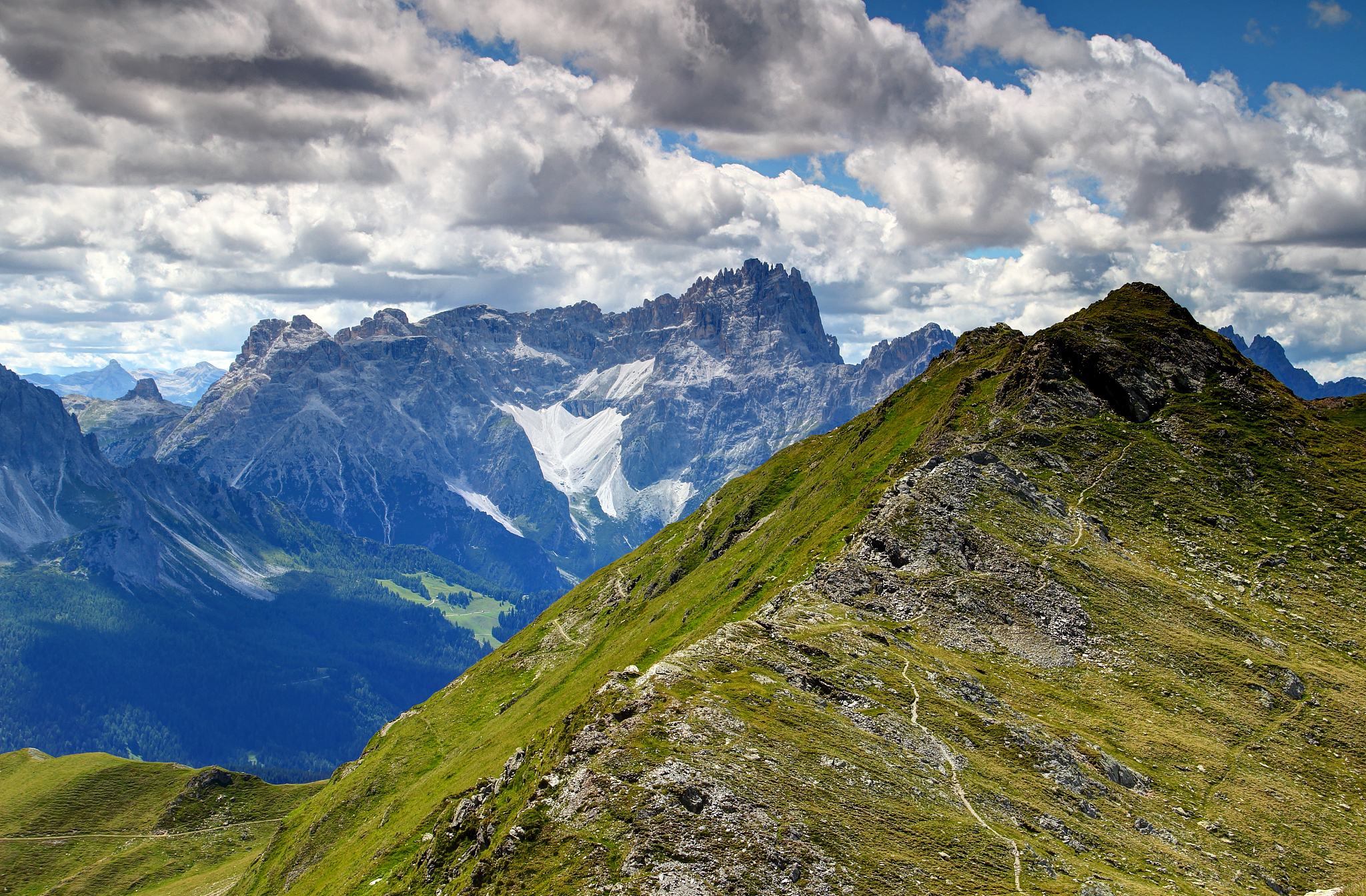 grassy carnic alps with jagged peaks of sexten dolomites, italy