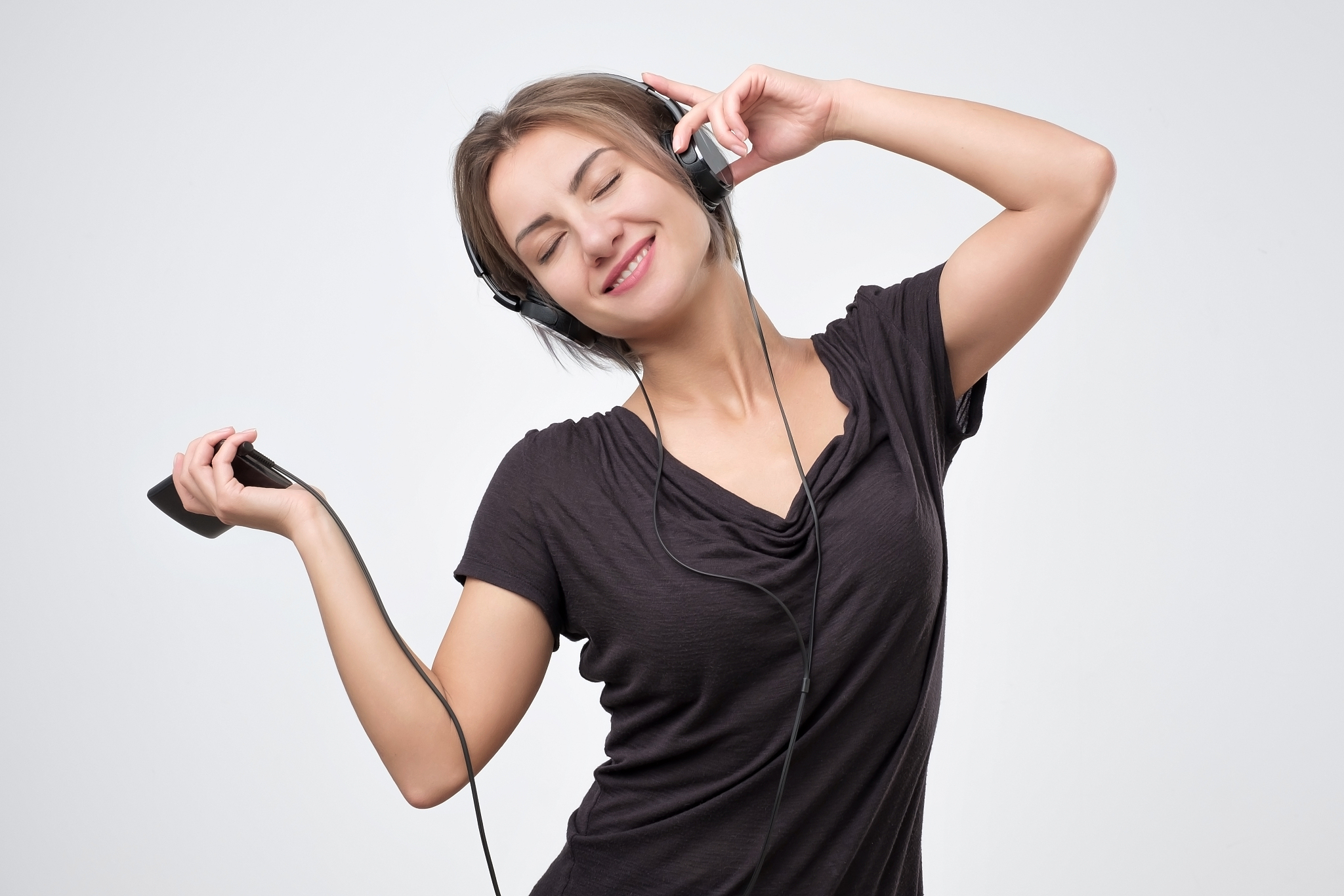 european woman joyful listening to music on mobile phone.