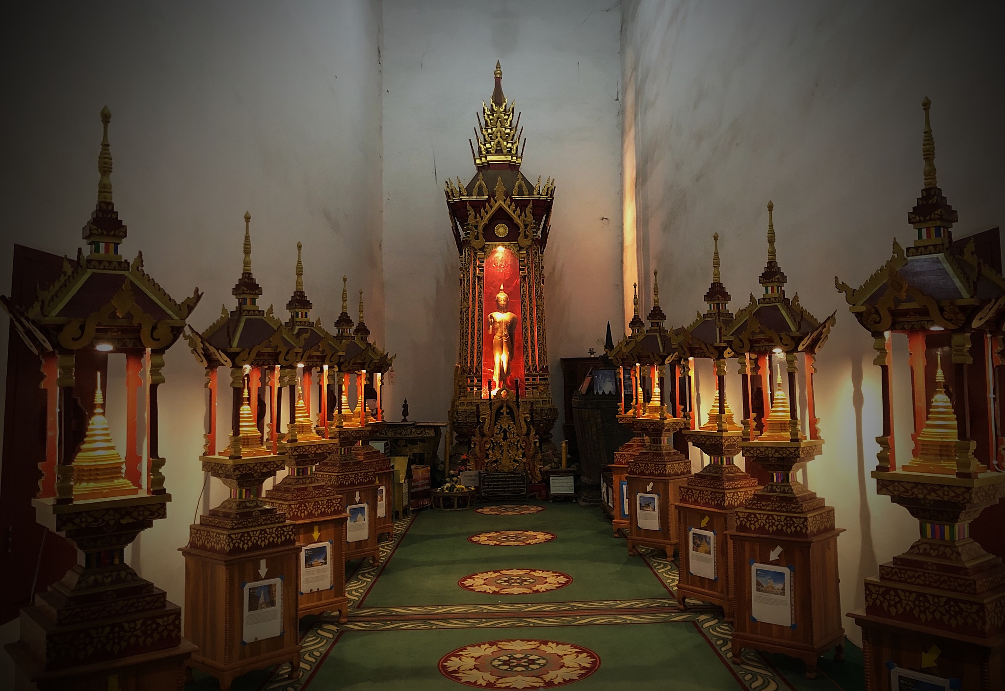 standing antiue buddha image in the hall of thai temple, wat cha