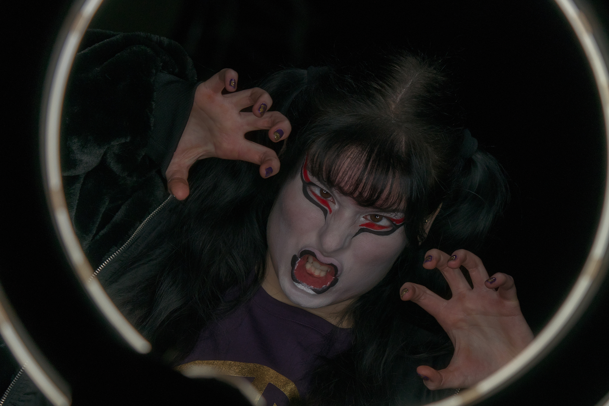 girl with a make-up in the form of a witch or a demon makes a fa