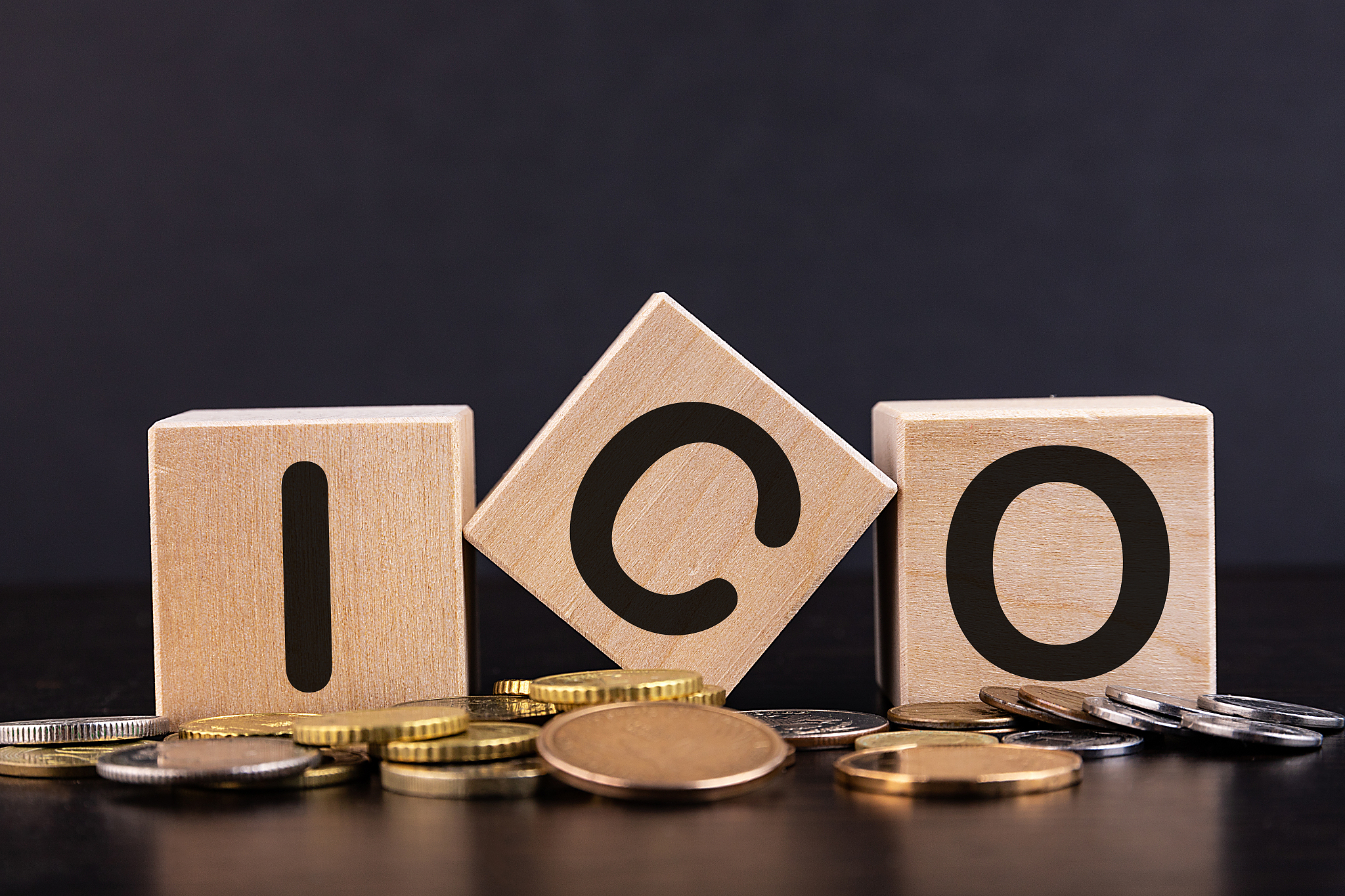 ico the initial offer of coins is written on wooden cubes. gold 