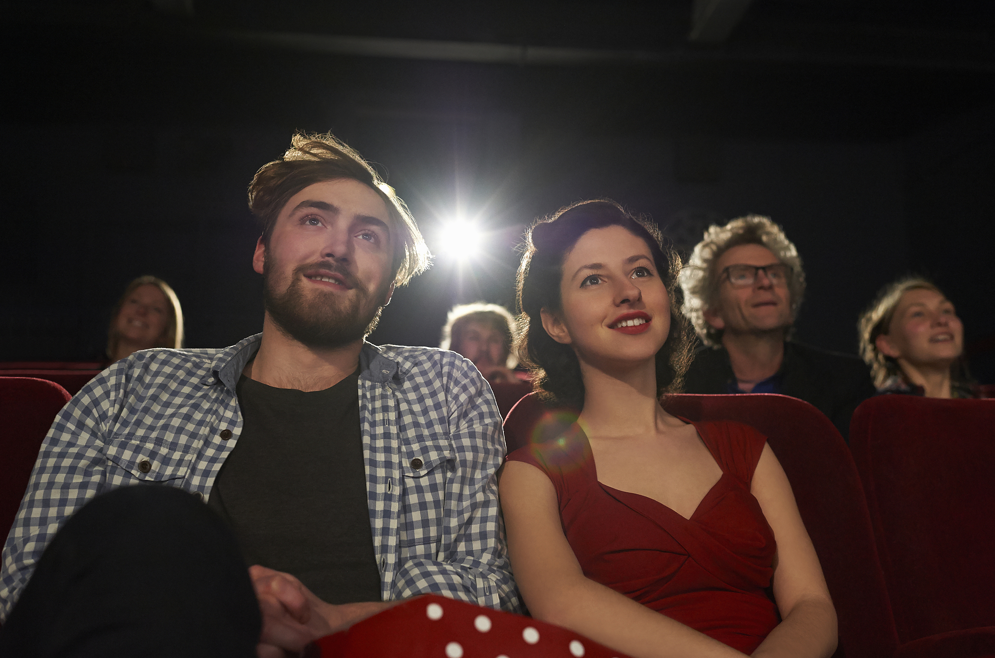 couple watching film in movie theatre.
